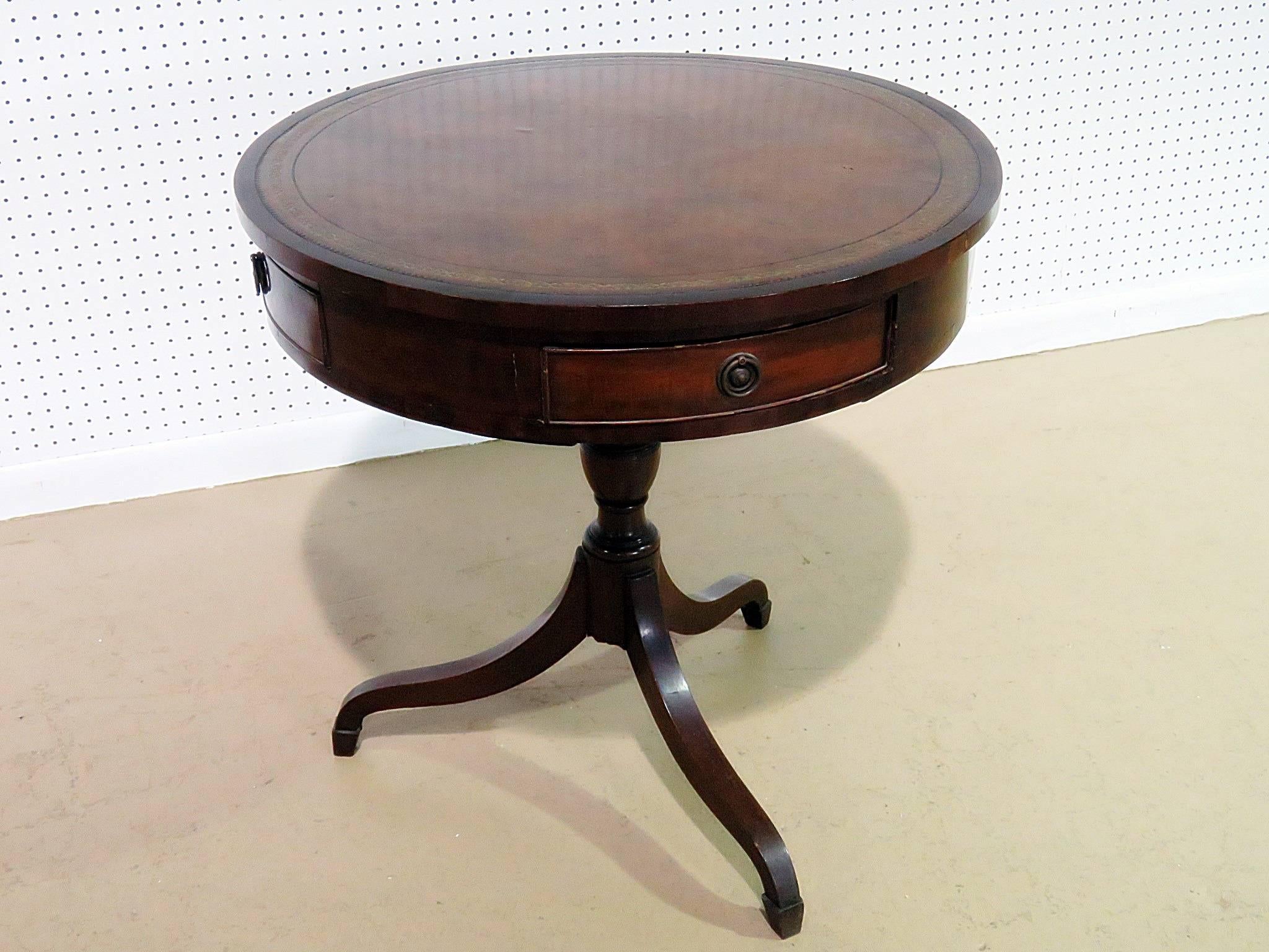 19th century traditional English leather top revolving drum table with four drawers.