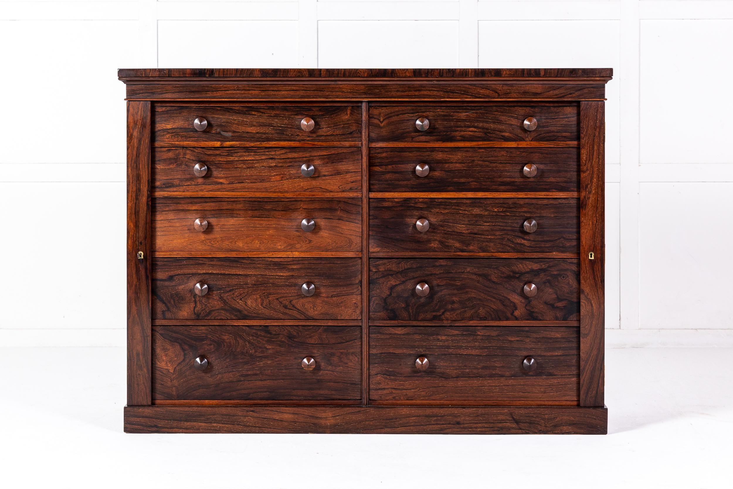 A 19th Century English Rosewood Collector's Chest or Bank of Lockable Drawers.

Made in England in the middle of the 19th century, this fine piece of furniture was designed as the filing cabinet of its day. It incorporates two independent banks of