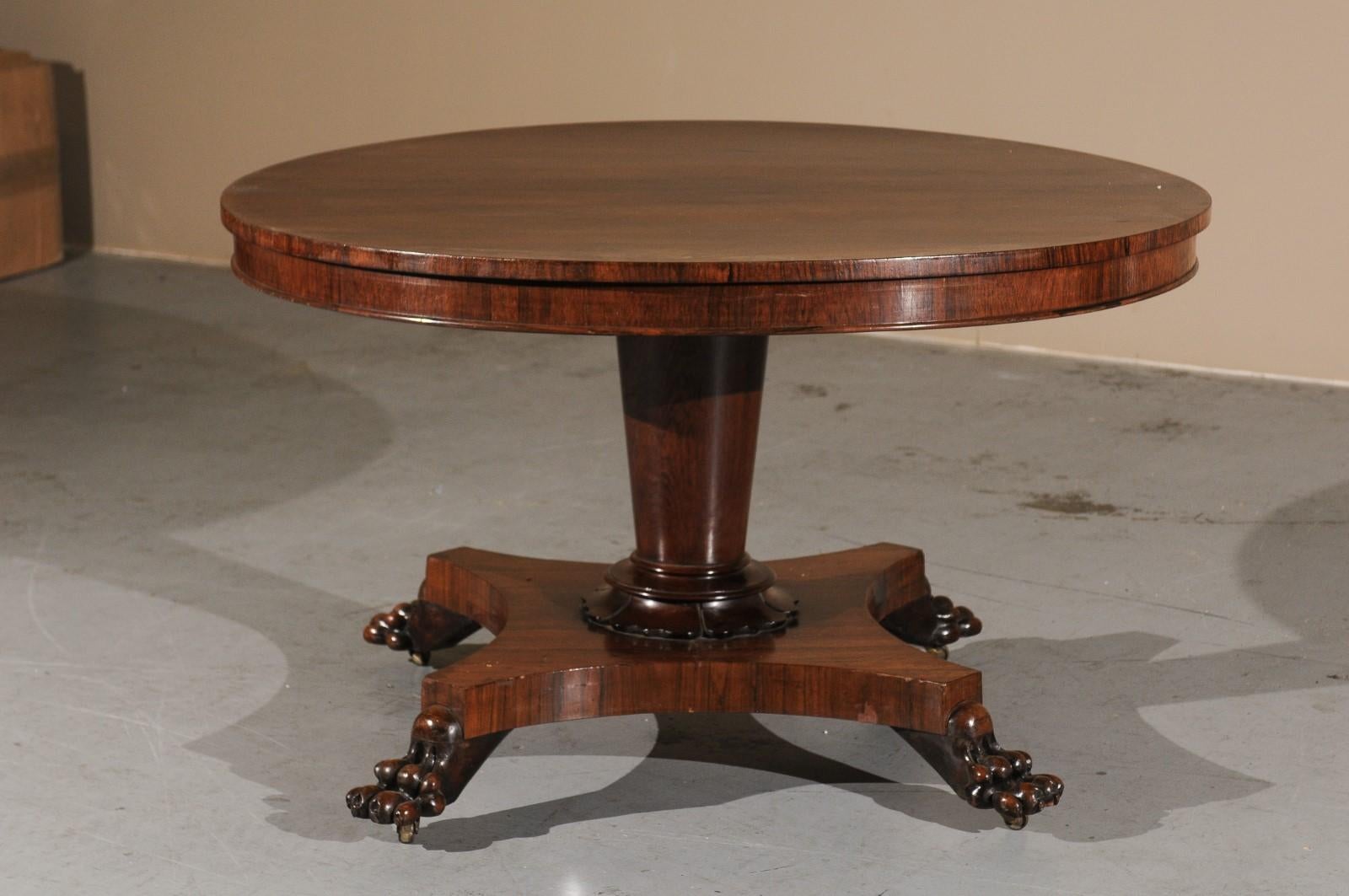 19th Century English rosewood center table with pedestal base & paw feet.