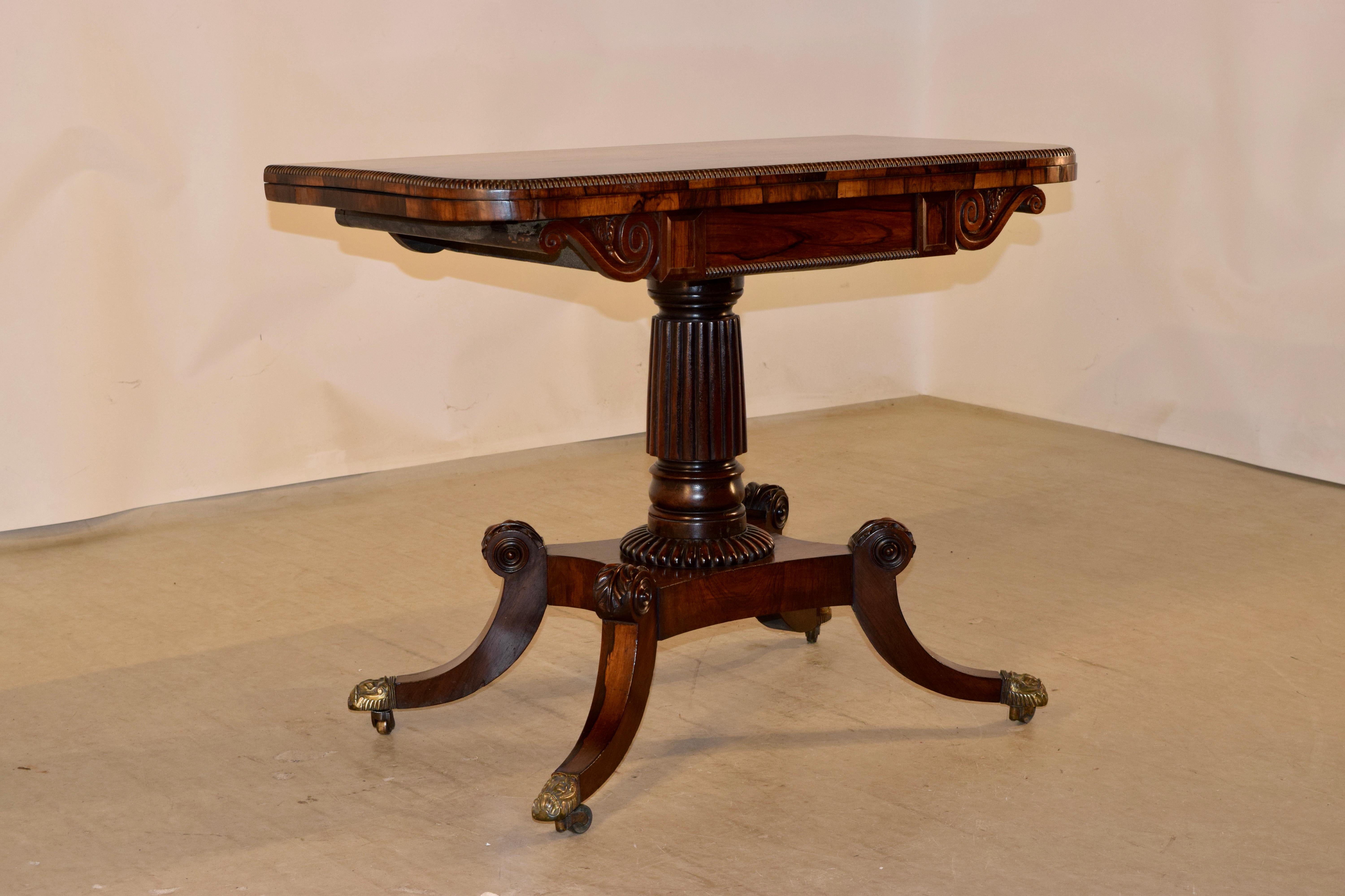 A fine 19th century rosewood game table from England. The curved front has a hand beaded edge and wonderfully grained as well. The table top is constructed ingeniously to fold open and slide or swivel before resting flat. When the game table top is