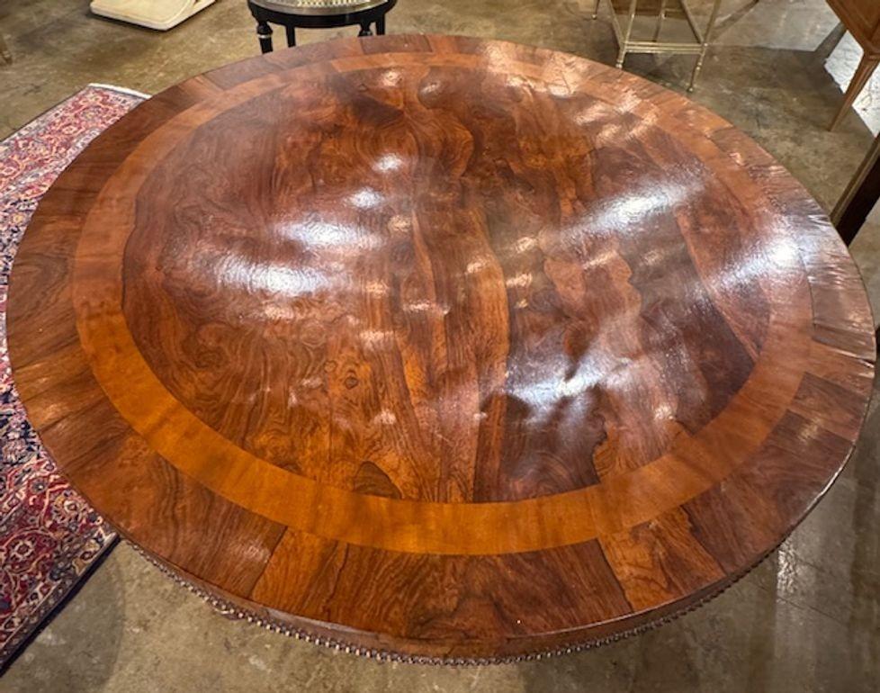 This 19th century English rosewood pedestal table exudes elegance and sophistication. The table, features a beautiful polished wood finish  and subtle carvings.  A super elegant choice for a  timeless classic look that adds charm to any home. A