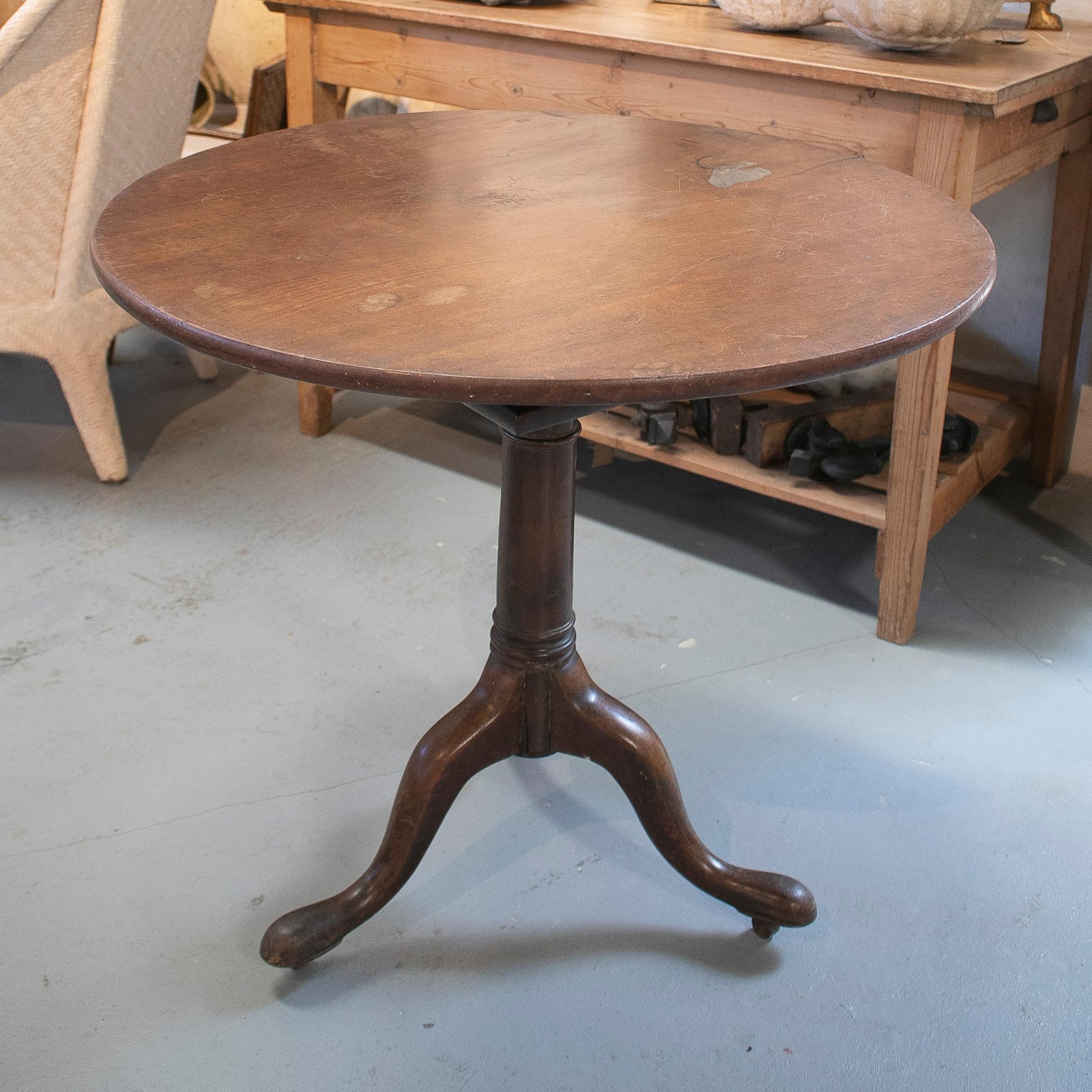 Antique 19th century English round pedestal table with bronze wheels on each foot. Measures: 3-feet.
 