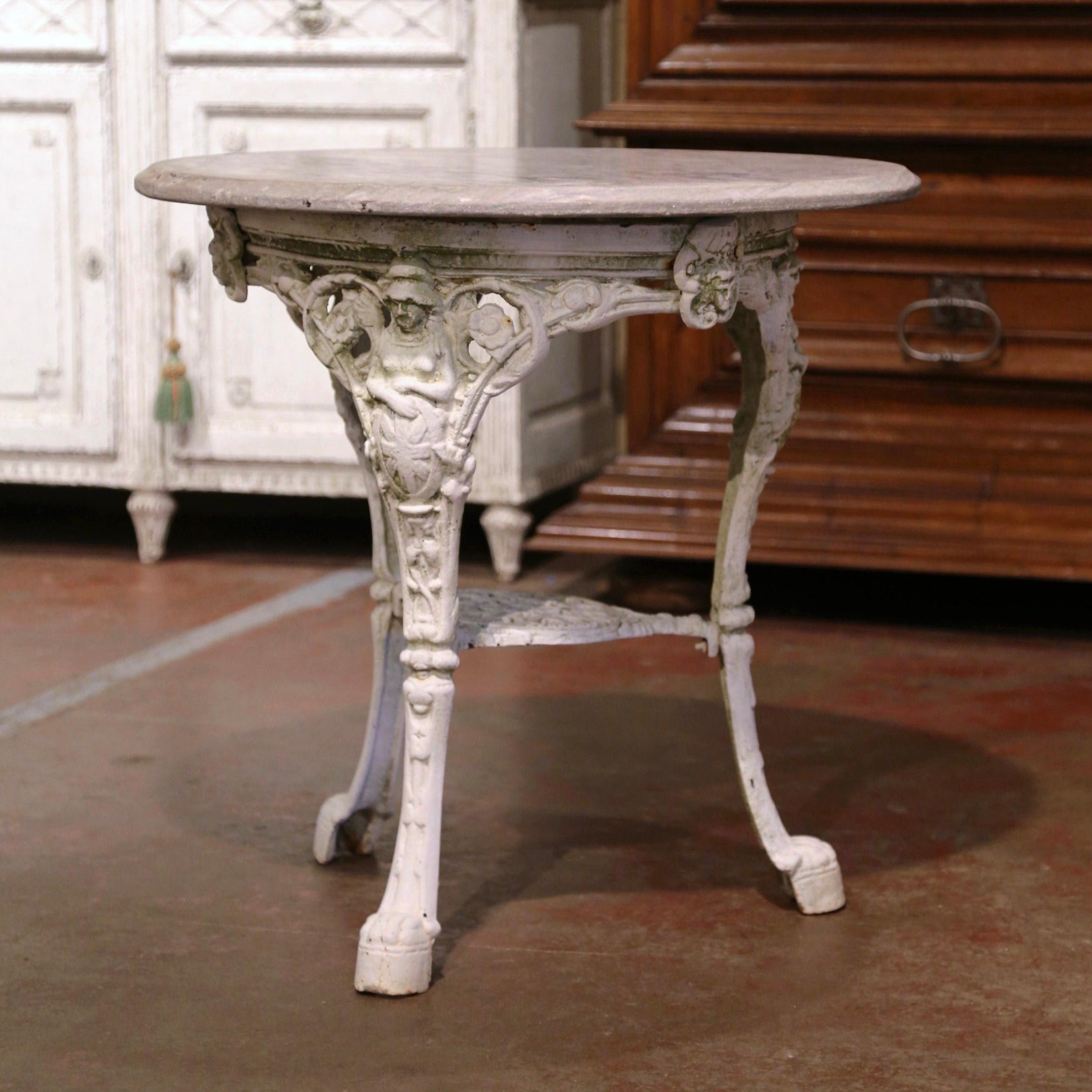 Decorate a patio, a pool area, or sun room with this elegant antique three-leg gueridon table. Crafted in England circa 1880, the pub table stands on three cabriole legs ending with paw feet decorated with female figures at the shoulder; the legs