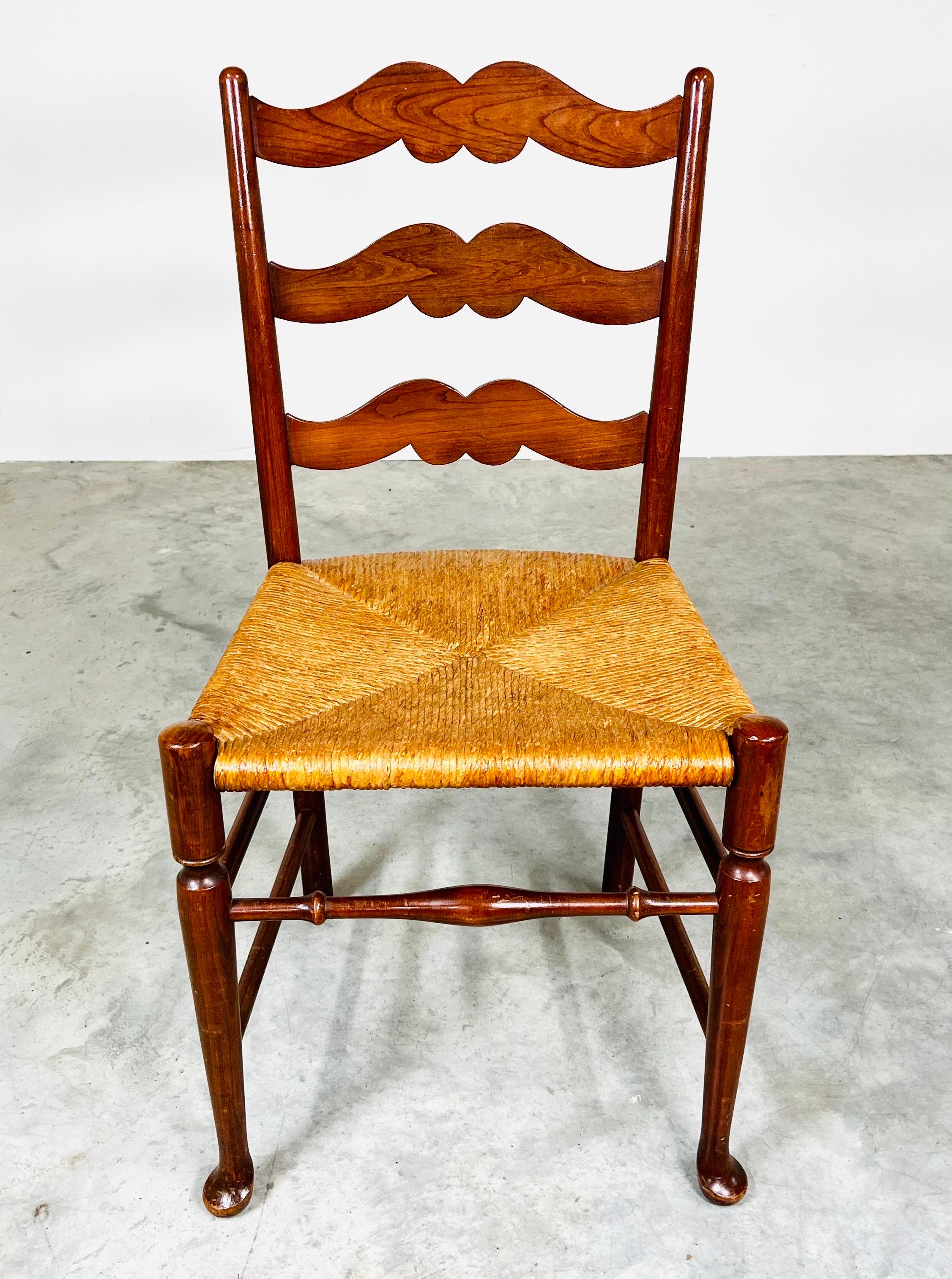 An attractive corner, accent or desk chair in Cherry having strong rush seat with ladder back frame. In excellent condition having strong, solid joints and tightly woven rush seat with clean finish. 
England, circa 1890. 
Measures: 35x18x17.5” HWD