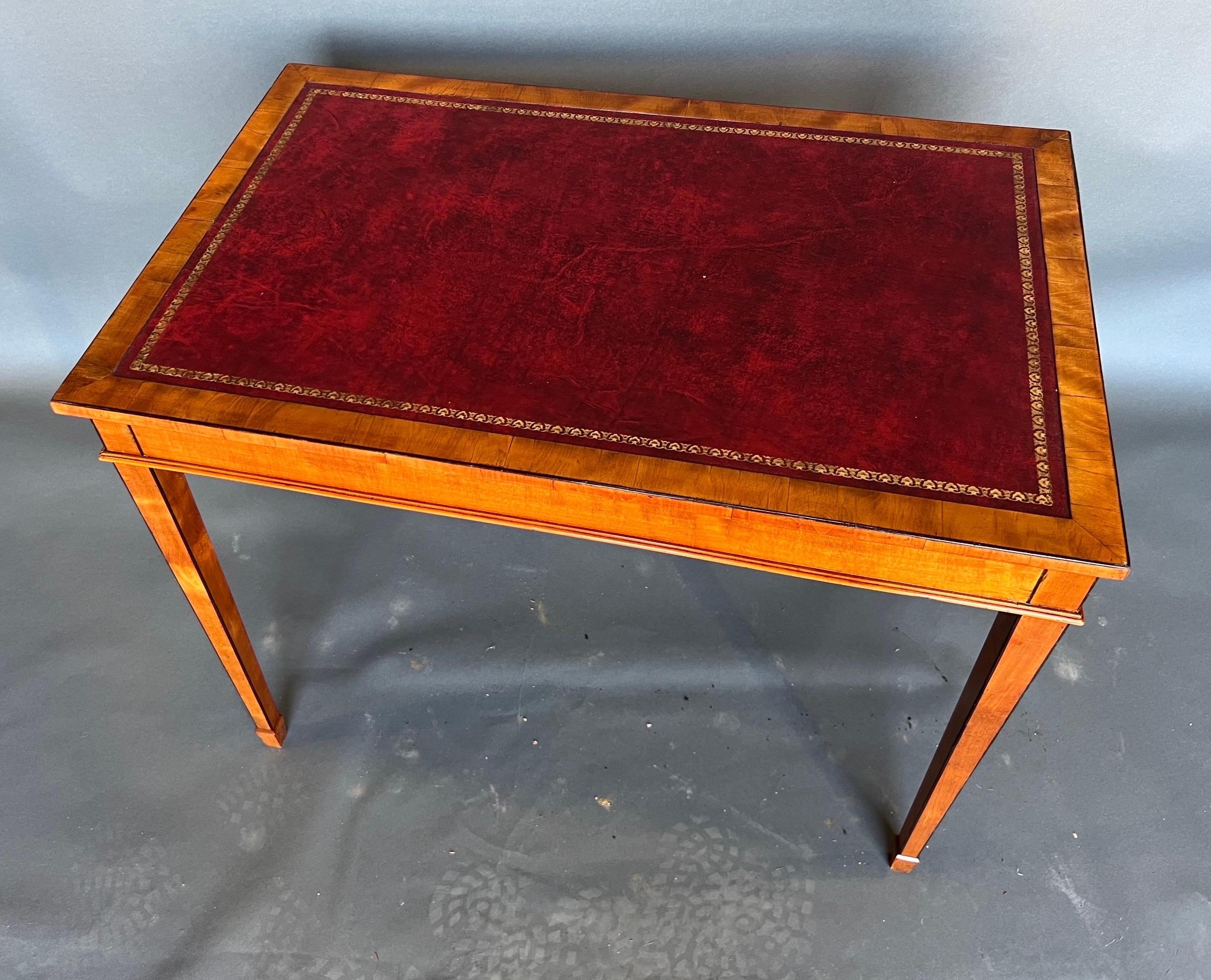 19th century English Edwardian period satinwood and leather top table. Very pretty color and the smaller scale makes it a much more versatile option as a side table or console.