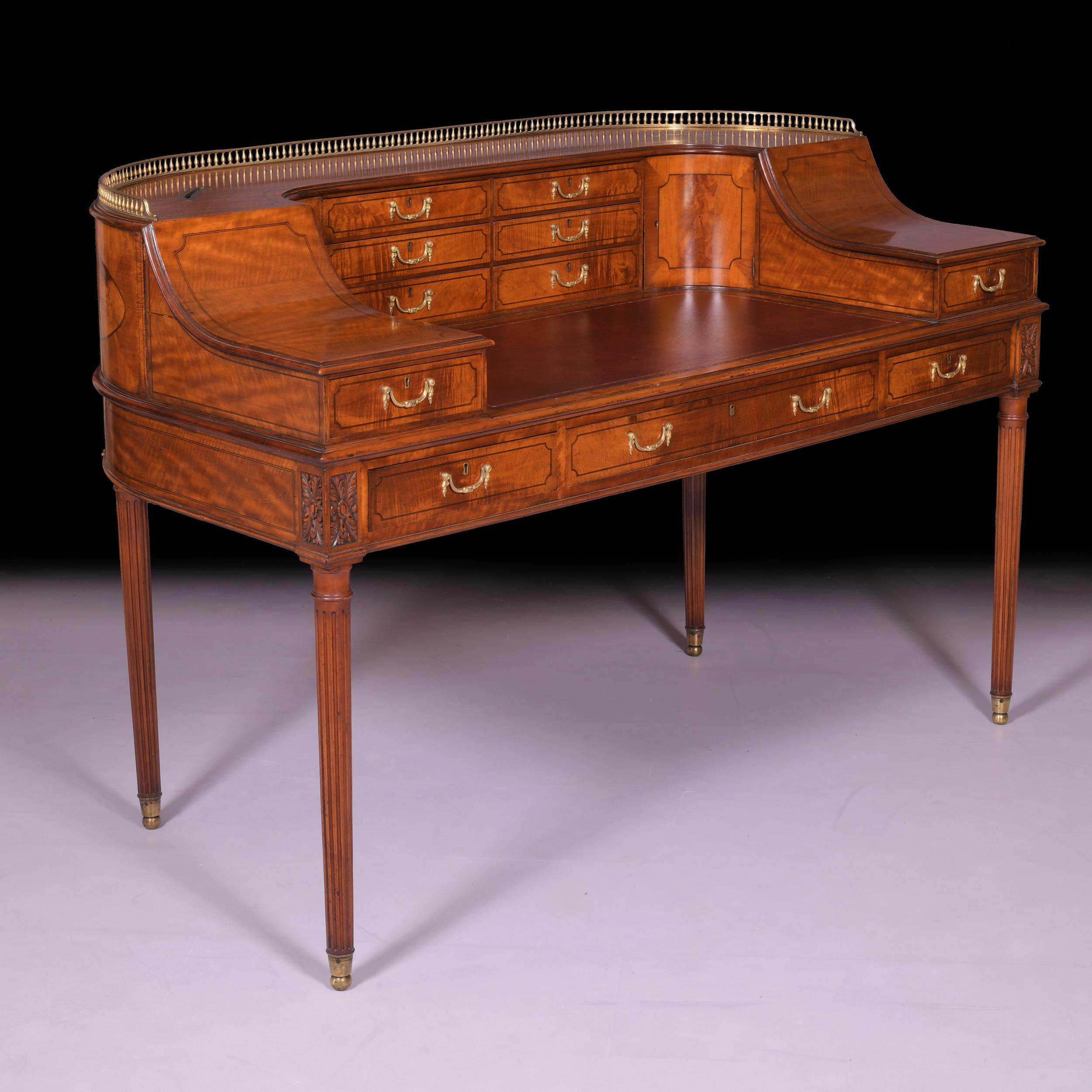 An exceptional 19th century satinwood Carlton House desk attributed to Gillows of Lancaster, the curved superstructure with pierced brass gallery, fitted with two banks of three drawers to the centre, flanked by cupboard doors, the left & right with
