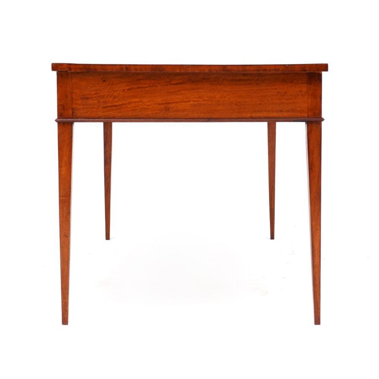 19th century English satinwood bureau plat or writing desk. Inset embossed red leather top, satinwood case, three drawers, tapered legs. Finished on All Sides

Overall 28.75
