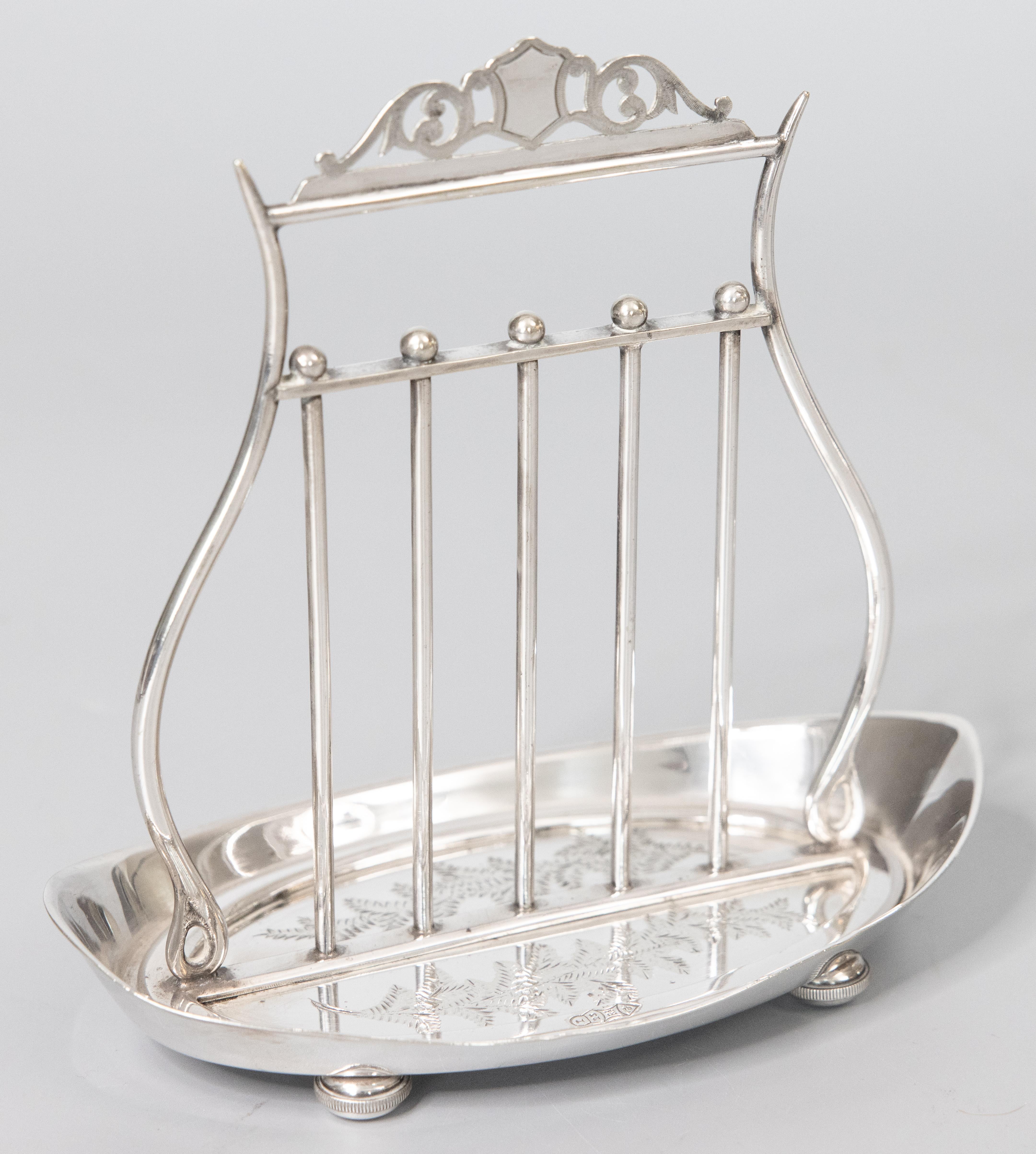 A lovely antique English silverplate lyre shaped letter holder by Thomas Bradbury of Sheffield, dated 1872. Hallmarks on base. This beautiful letter rack has a Neoclassical design with an elegant lyre shape, etched foliate decoration, and charming
