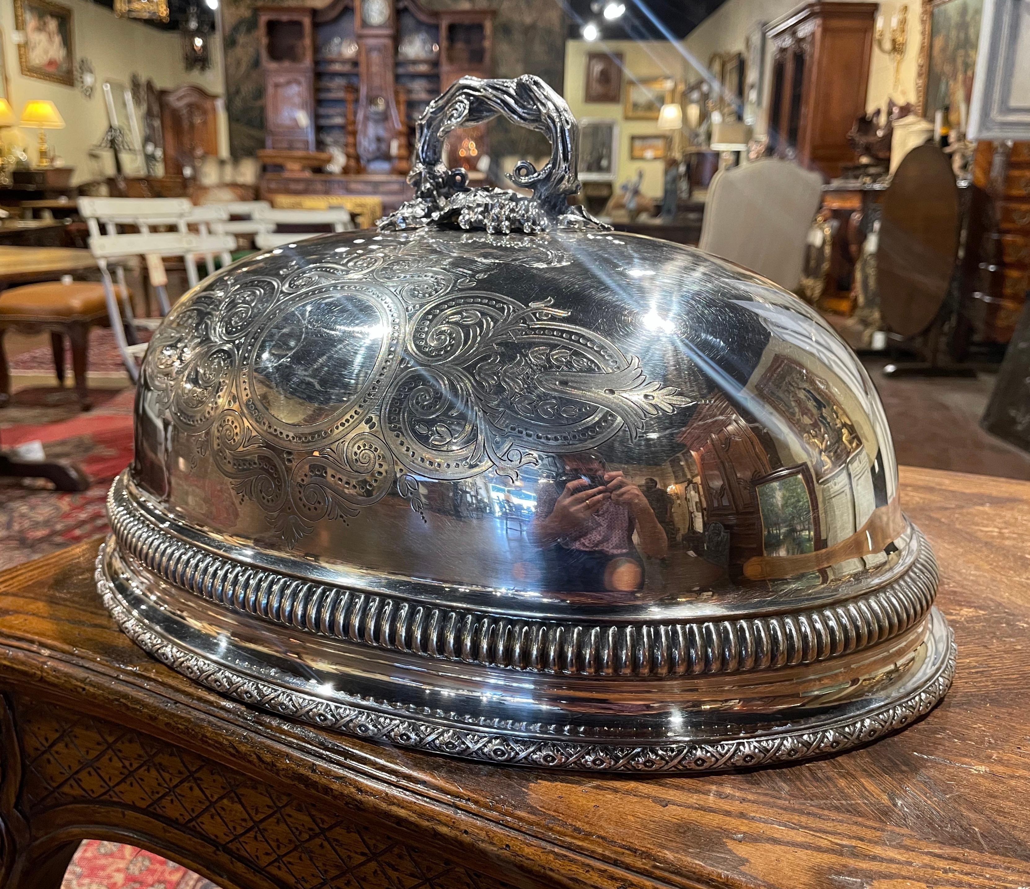 This elegant, antique copper dome likely Sheffield, was created in England, circa 1870. Oval in shape, the traditional meat cover has a fluted body and is topped with a naturalistic tree like handle embellished with vine and grape motifs in high