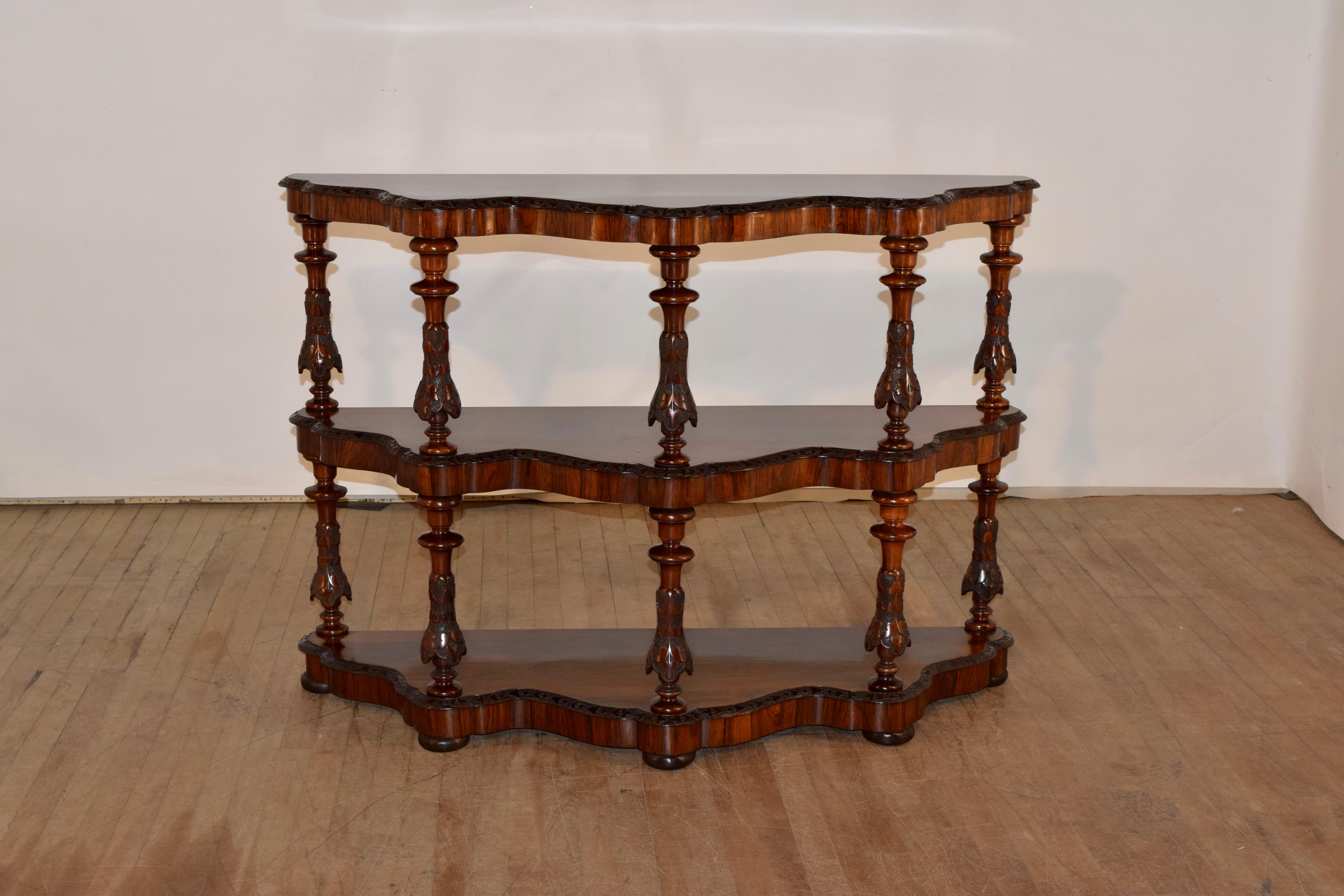 19th century English rosewood shelf from England. This is an exquisite shelf with wonderfully grained wood. The shelves have scalloped fronts and the edges are beveled and carved decorated. There are also banded aprons below the shelves and the