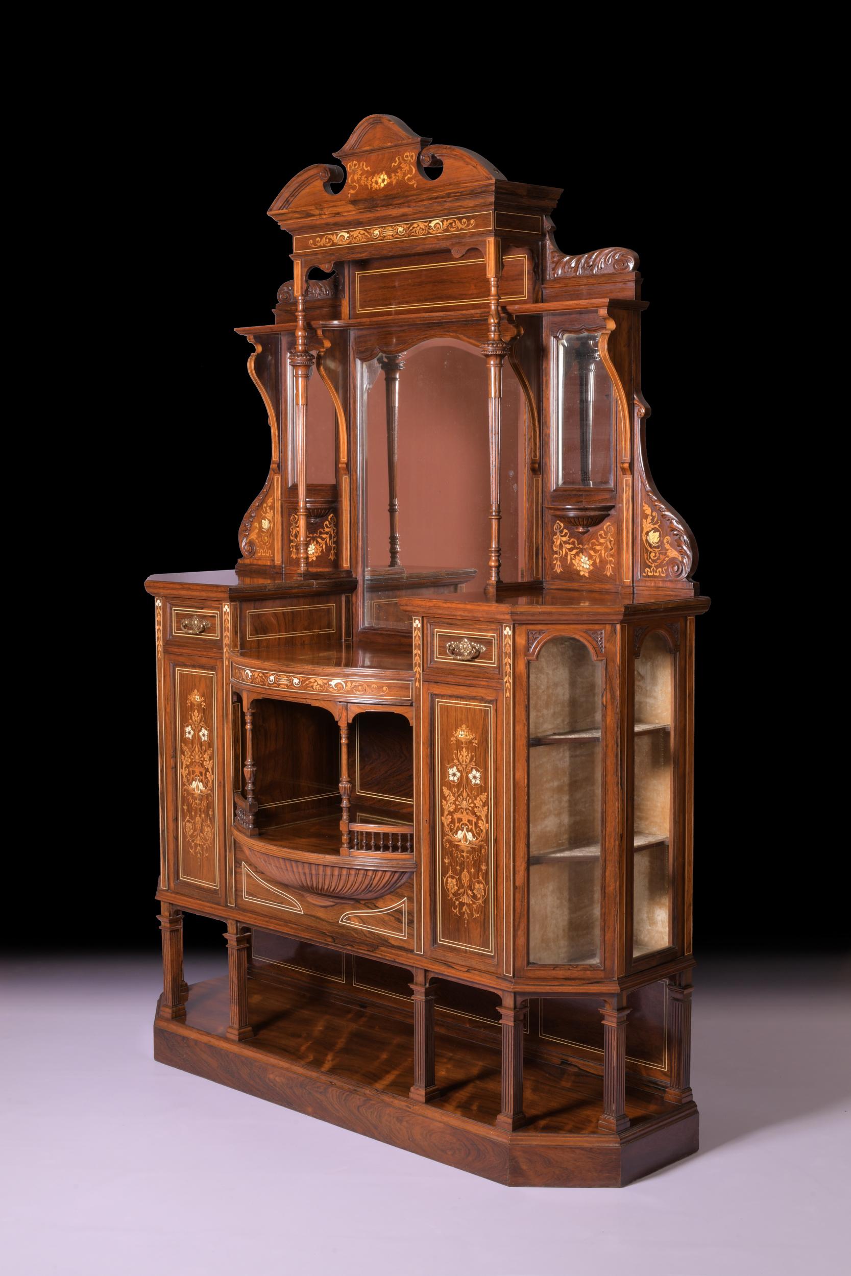 A very fine 19th century rosewood, marquetry and ivory inlay drawing room cabinet, the superstructure with a moulded broken arch scroll pediment above a central bevelled mirror flanked by two bevelled mirrors, the middle section with two marquetry