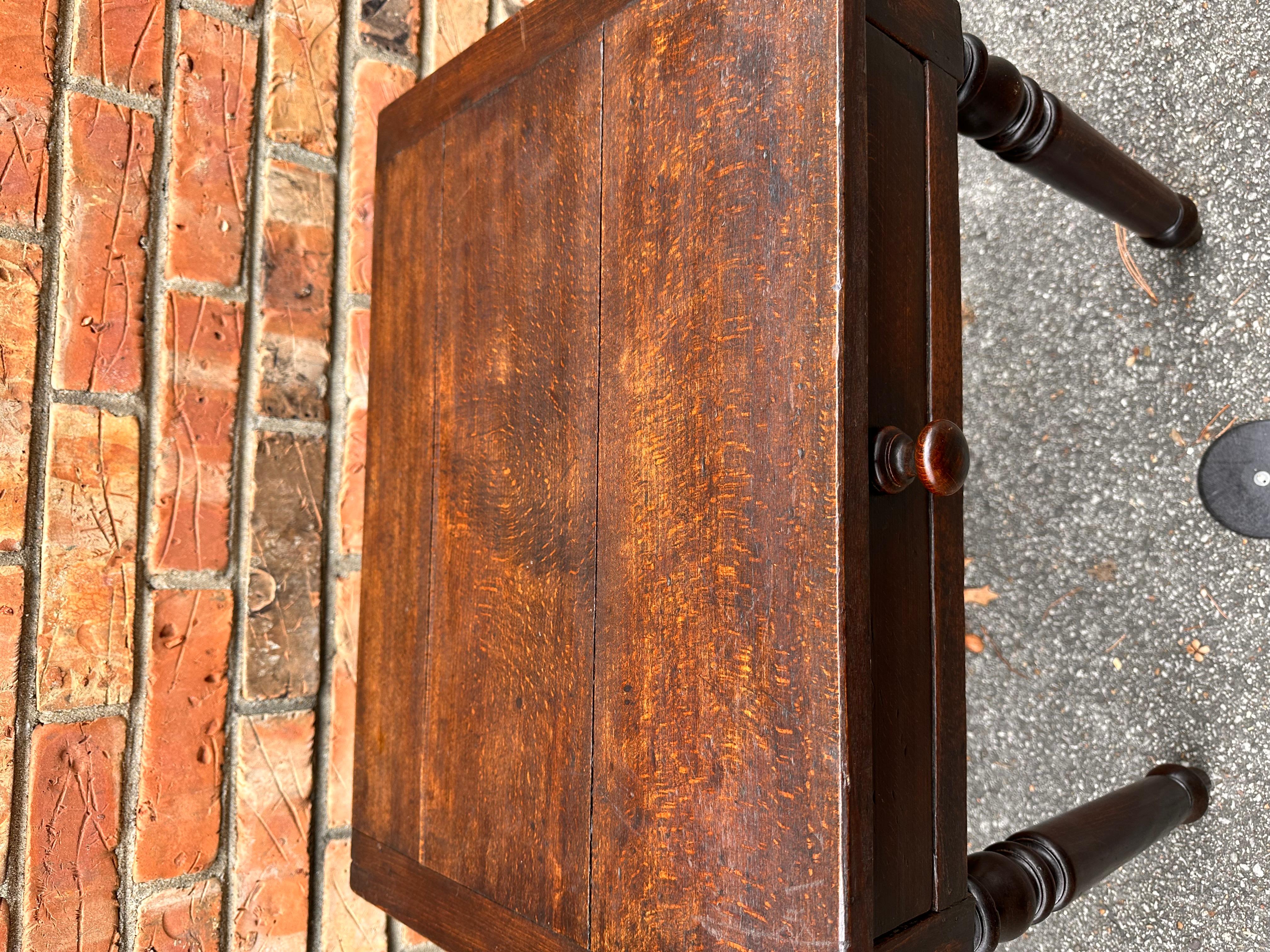 This is an adorable little antique side table features a single small drawer for added function! The rich deep wood tones of the table blend together beautifully and is intensified by this piece's lovely patina. It is a perfect way to add more table