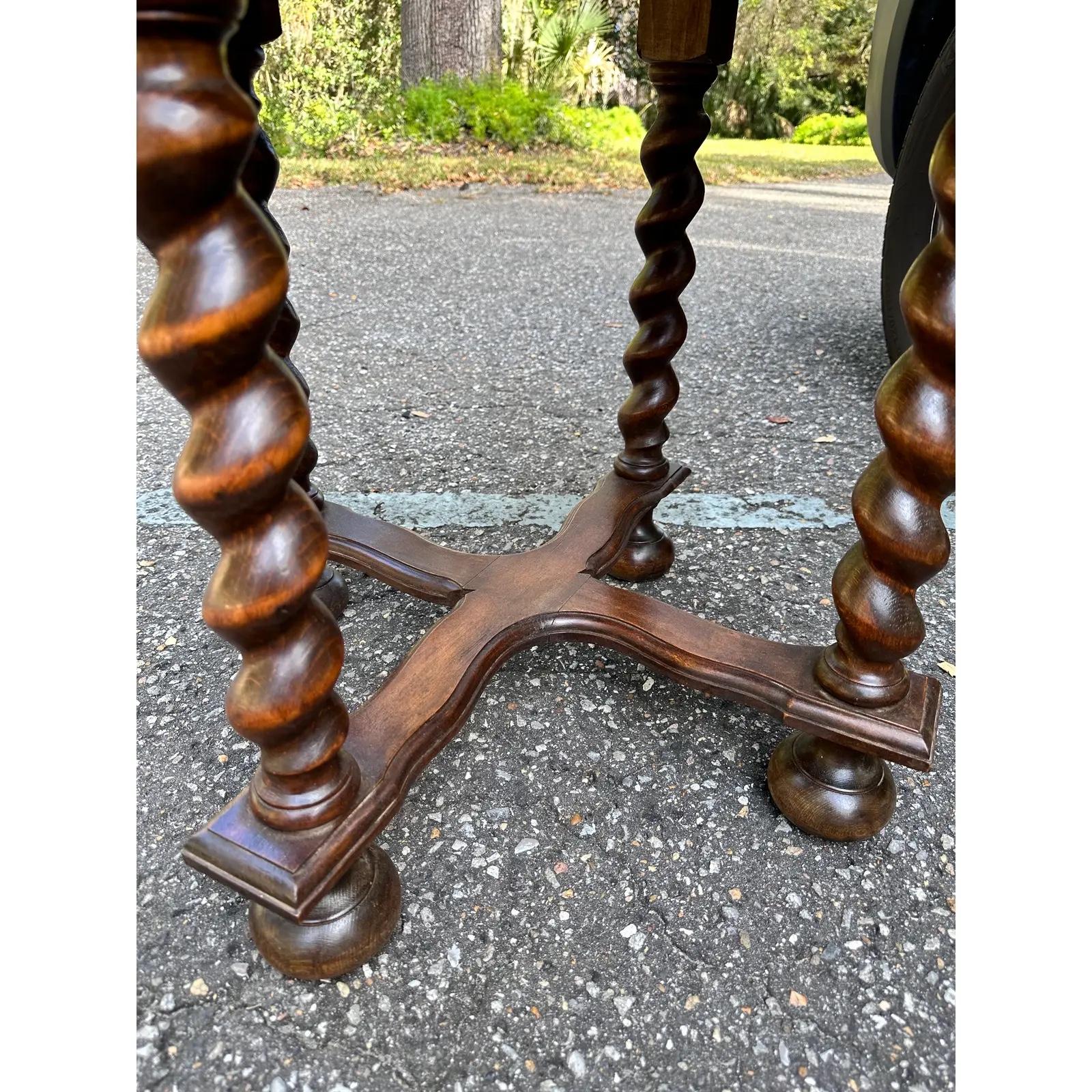 This is a beautiful 19th century English side table! This piece follows the barley twist style but with a unique flare. This table is much chunkier than the typical barley twist pieces with thick legs and large feet at the base the stretcher. This