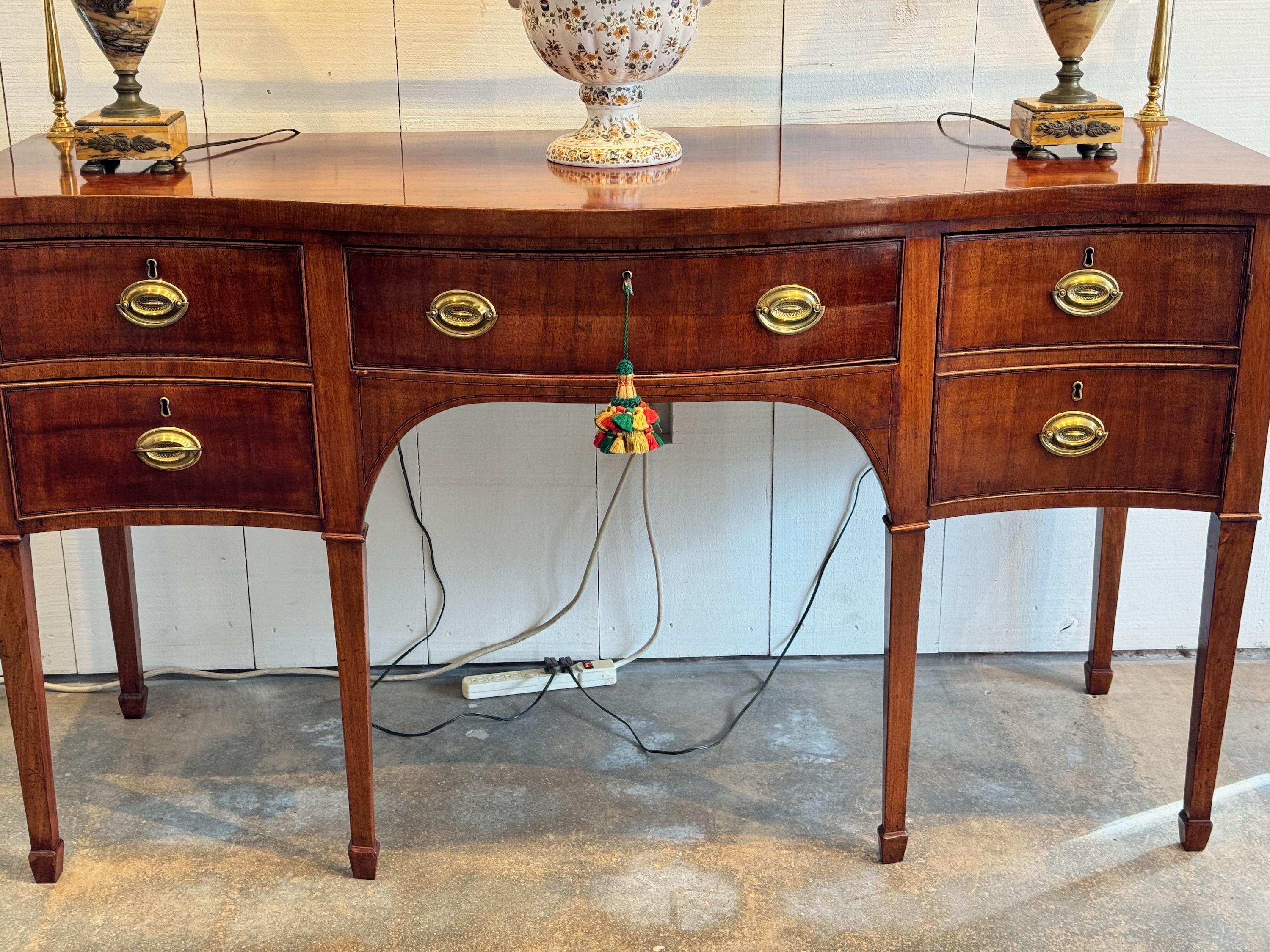 A beautiful Georgian Sideboard with a brass gallery. It can be removed .