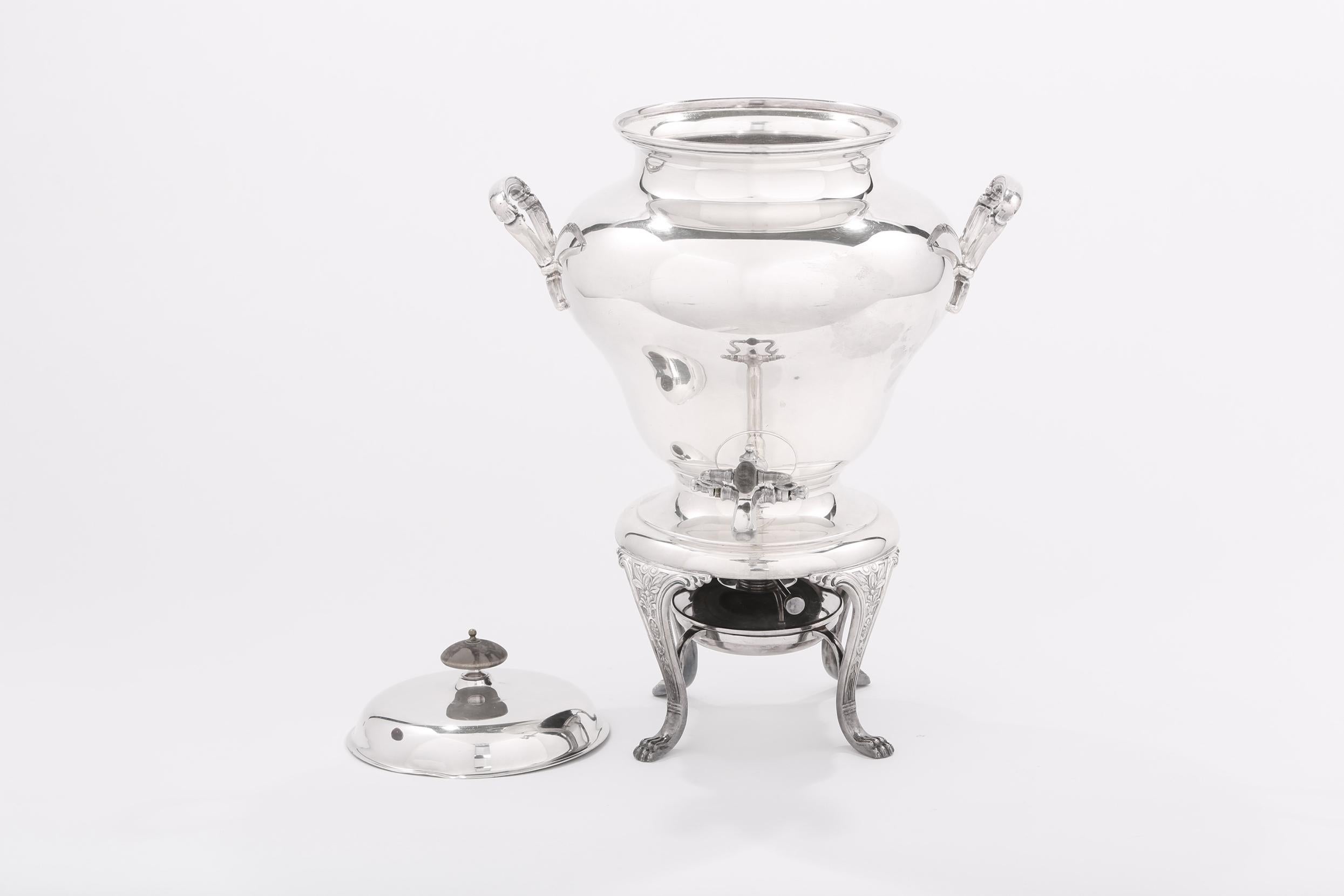 Late 19th century English silver plated samovar / tea or coffee urn with double handles and wood finial lid on four paw feet. The samovar / tea urn is in good antique condition. Minor wear consistent with age / use. Minor dent on the lid cover. The