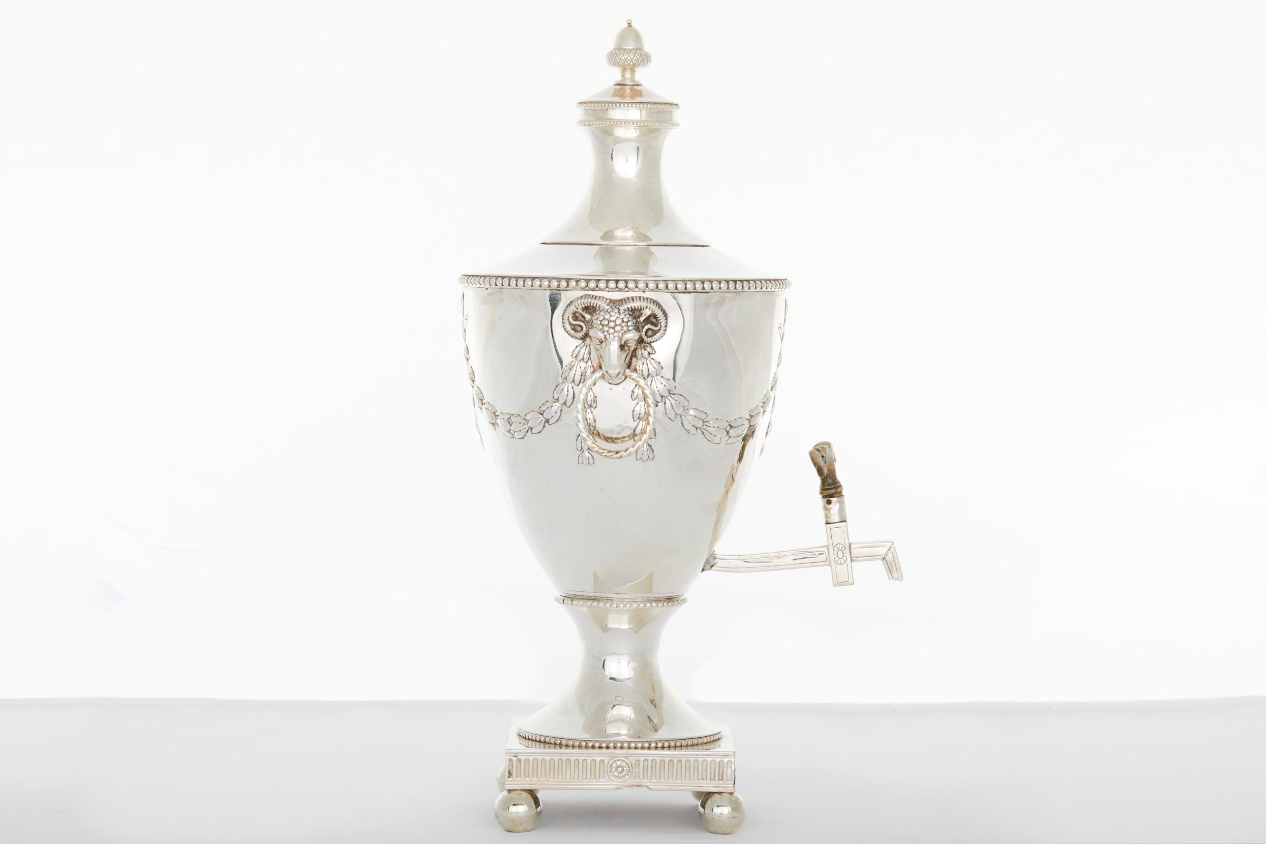 Mid 19th century English silver plated samovar / tea or coffee urn with Ram detail side handles and finial lid on square footed base . The samovar / tea urn is in good antique condition. Minor wear consistent with age / use. Minor dent on the body /