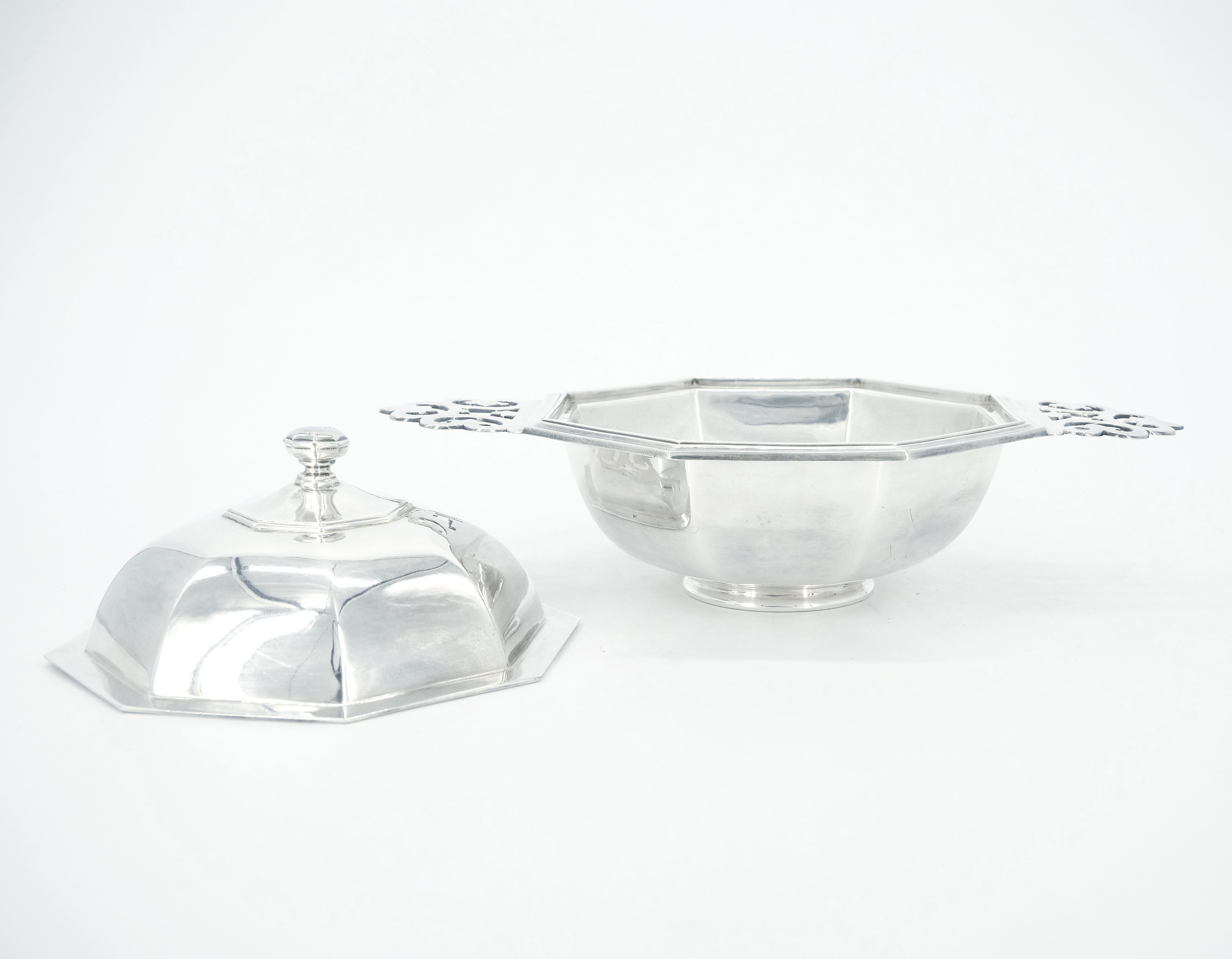 Antique octagonal shaped silver plate soup bowl with lid and pierced handles with fleur de lis motif from the English firm of Silversmiths and Goldsmiths Company of London. Underside with the firm's familiar mark that includes their trademark REGENT