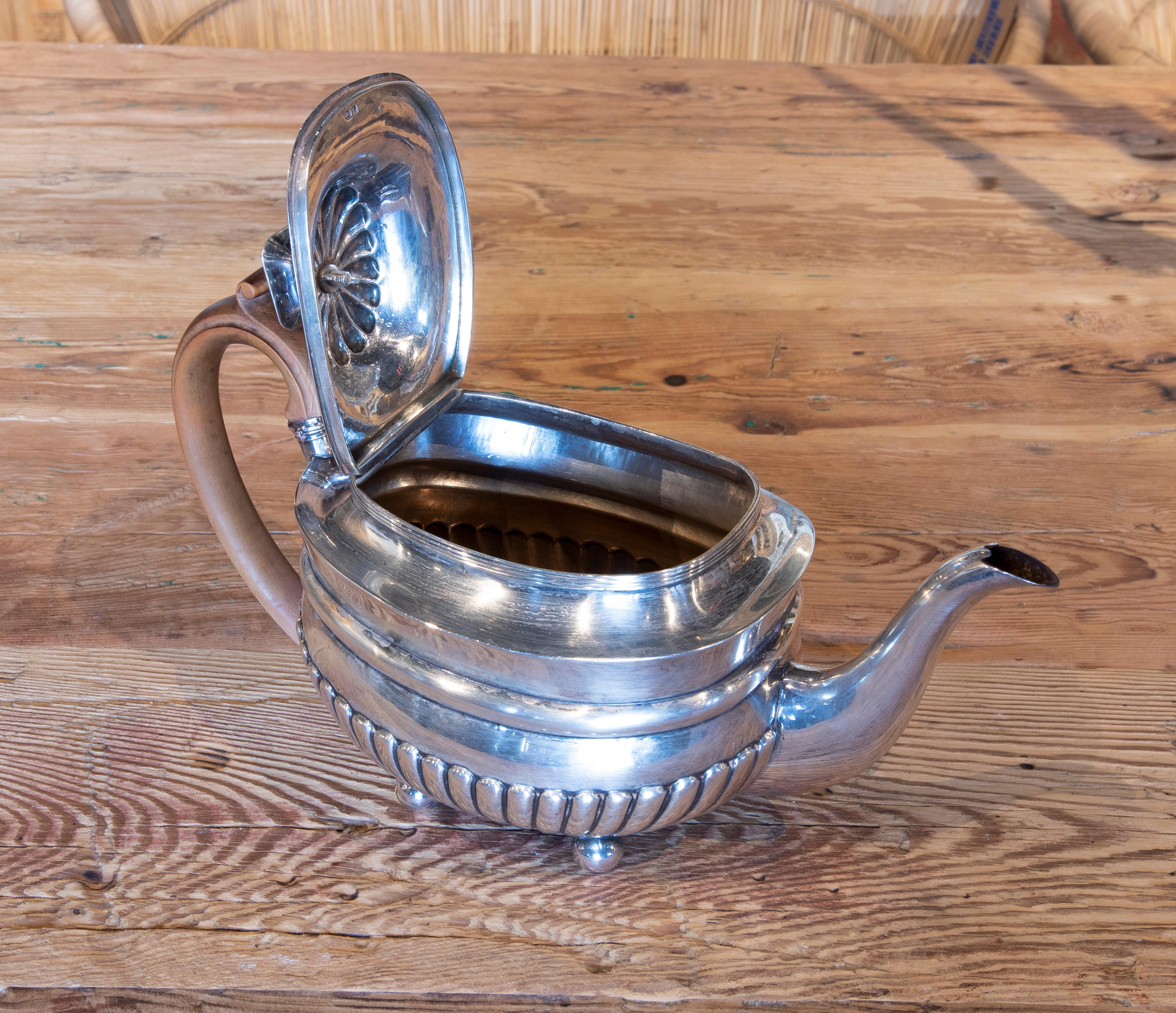 19th century English silver teapot with English wooden lid and handle.