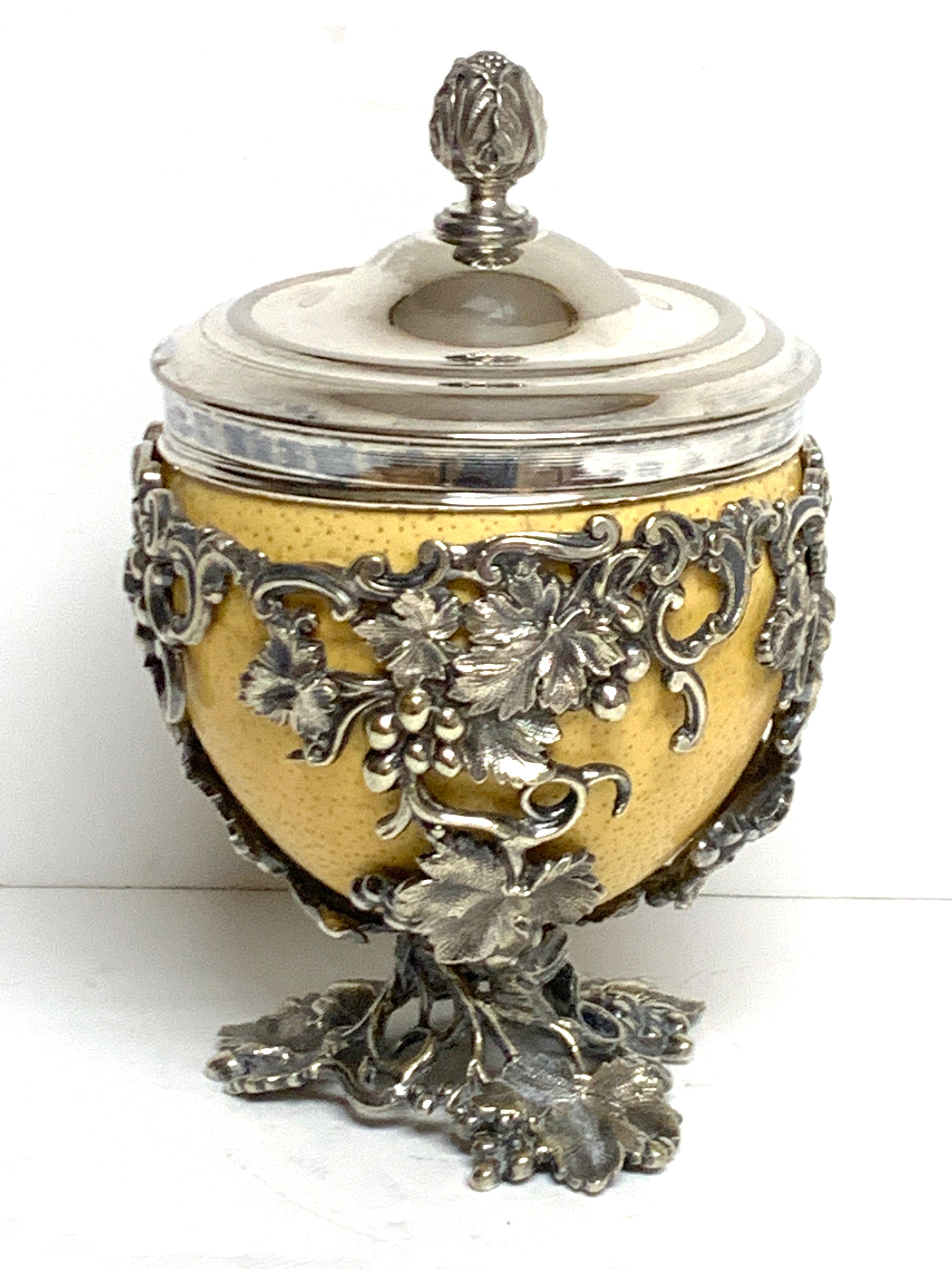19th century English silver plated ostrich egg box, attributed to Elkington & Co.
In three parts, the silver plated lid with Acanthus leaf handle, the silver rimed egg, and the grape leaf encrusted holder, unmarked.