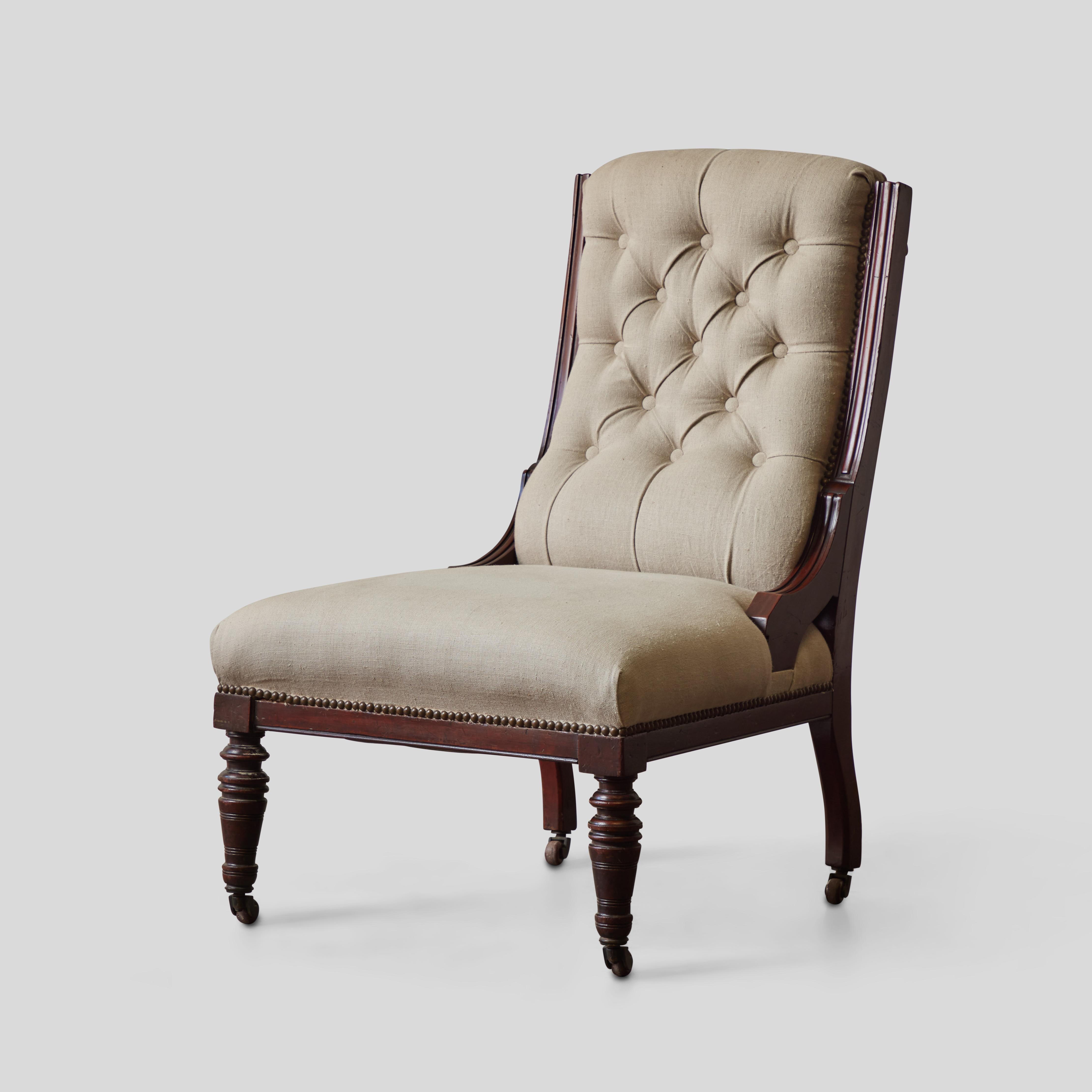 19th century English slipper chair. With its simple, Classic lines, carved mahogany framework and contemporary cream colored natural Belgian linen upholstery, the chair is comfortable, elegant Classic.

England, circa 1880

Dimensions: 25W x 29D