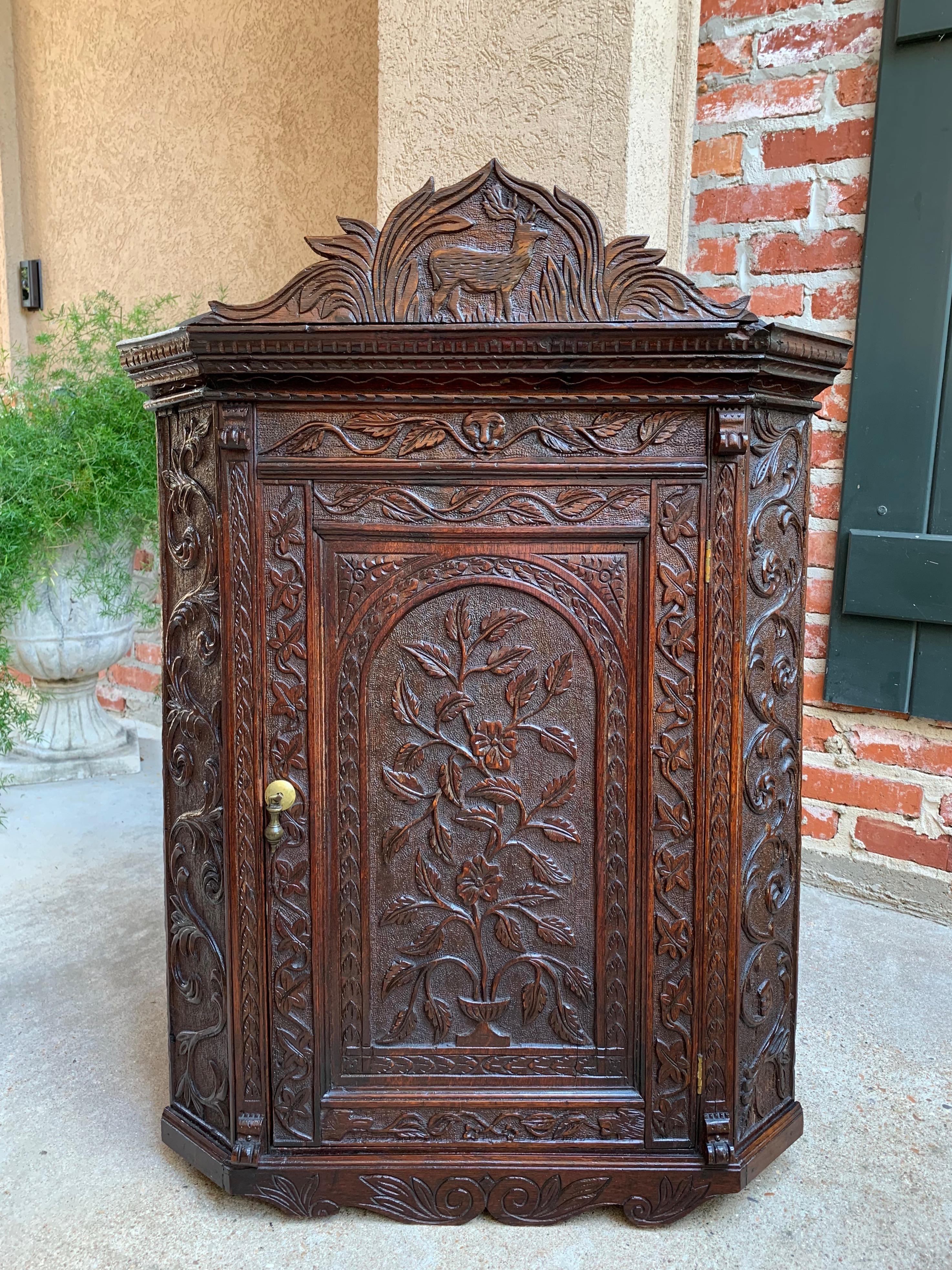 ~ Direct from England
~ Gorgeous antique English oak carved corner wall cabinet
~ Very old, hand carved designs on all the surfaces!
~ Upper crown has carved stag with antlers!
~ Hand carved designs across both sides
~ Paneled door has carved