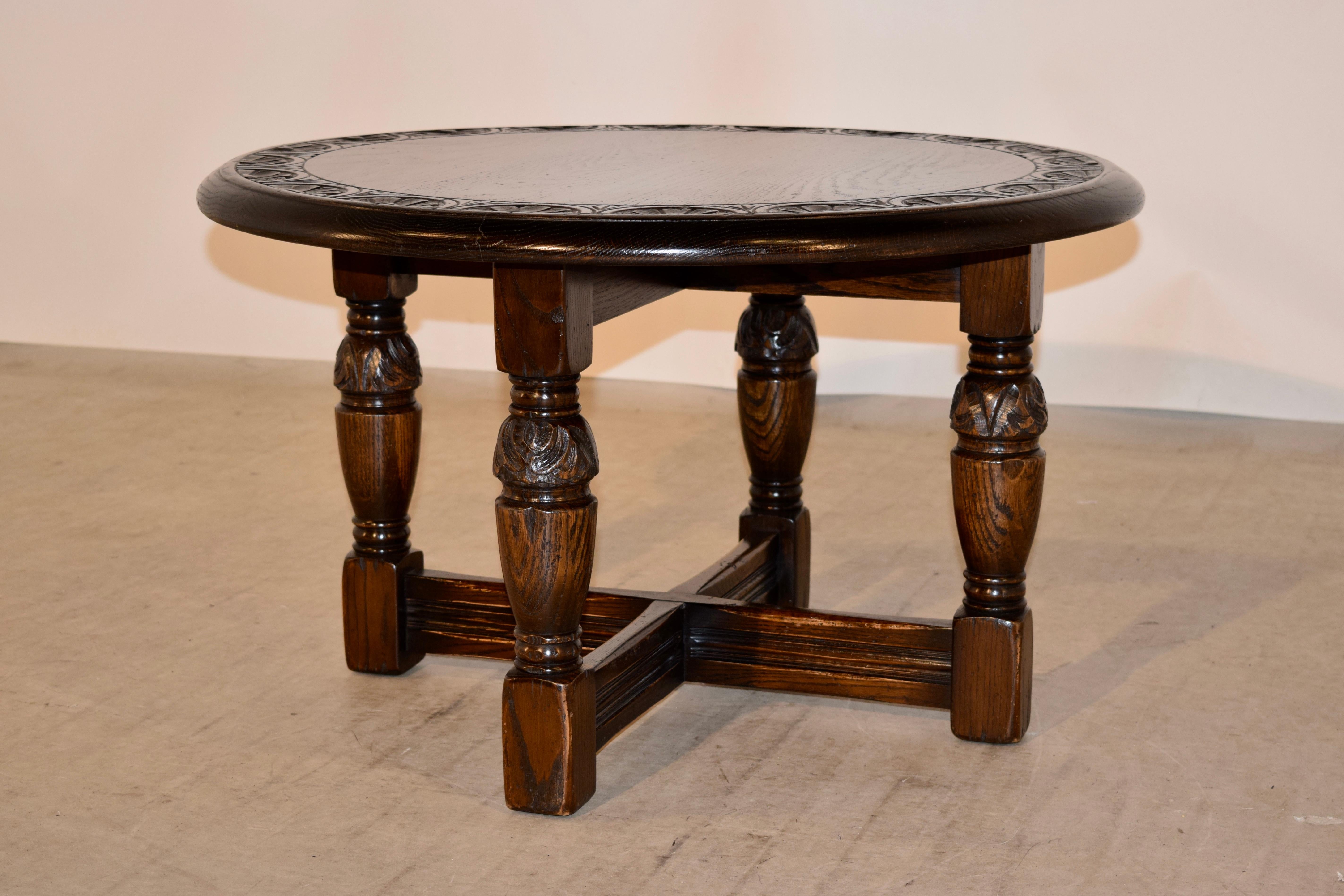 19th century coffee or cocktail table from England made from oak. The top has a beveled edge and is banded around the edge with hand carved decoration. The legs are also hand turned and carved decorated and are joined by cross stretchers.
