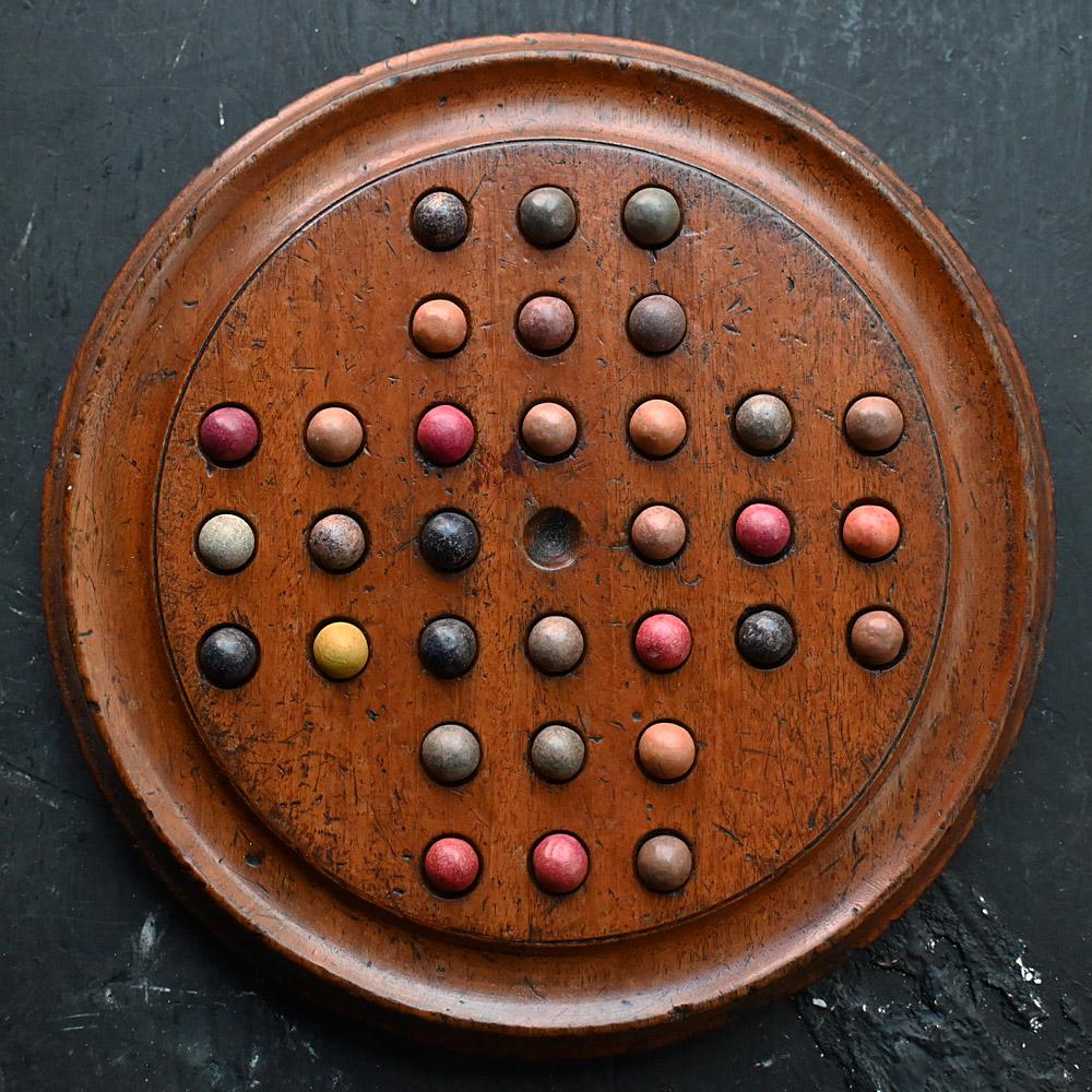 19th century English solitaire game

We share what we love and we love the well-used look of this late 19th century English solitaire game of coloured stone balls. The use of this game is evident in its condition and look, with a deep natural