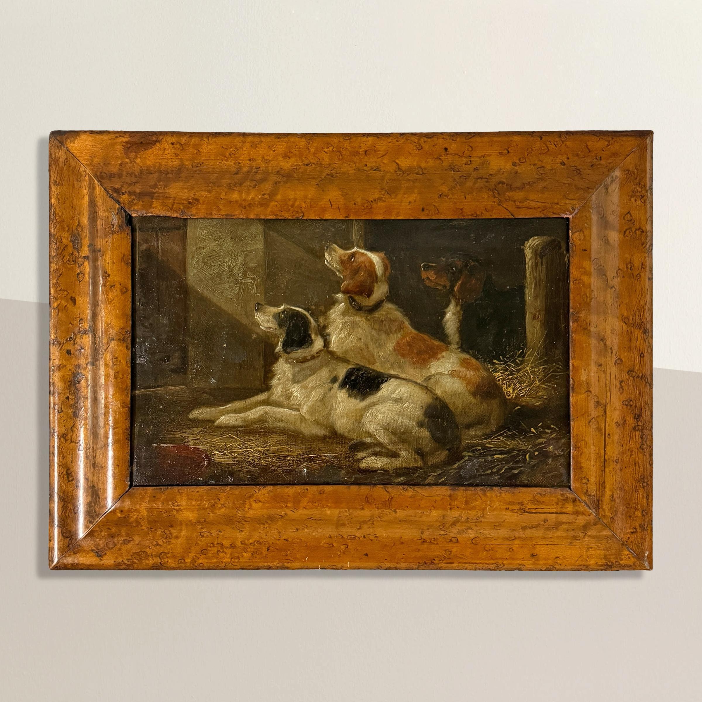 In this exquisite 19th-century English oil on board painting, the rustic charm of a country barn comes to life as three spaniels rest peacefully in a bed of straw. Their attentive gazes, fixed upward and out of frame, suggest anticipation as they