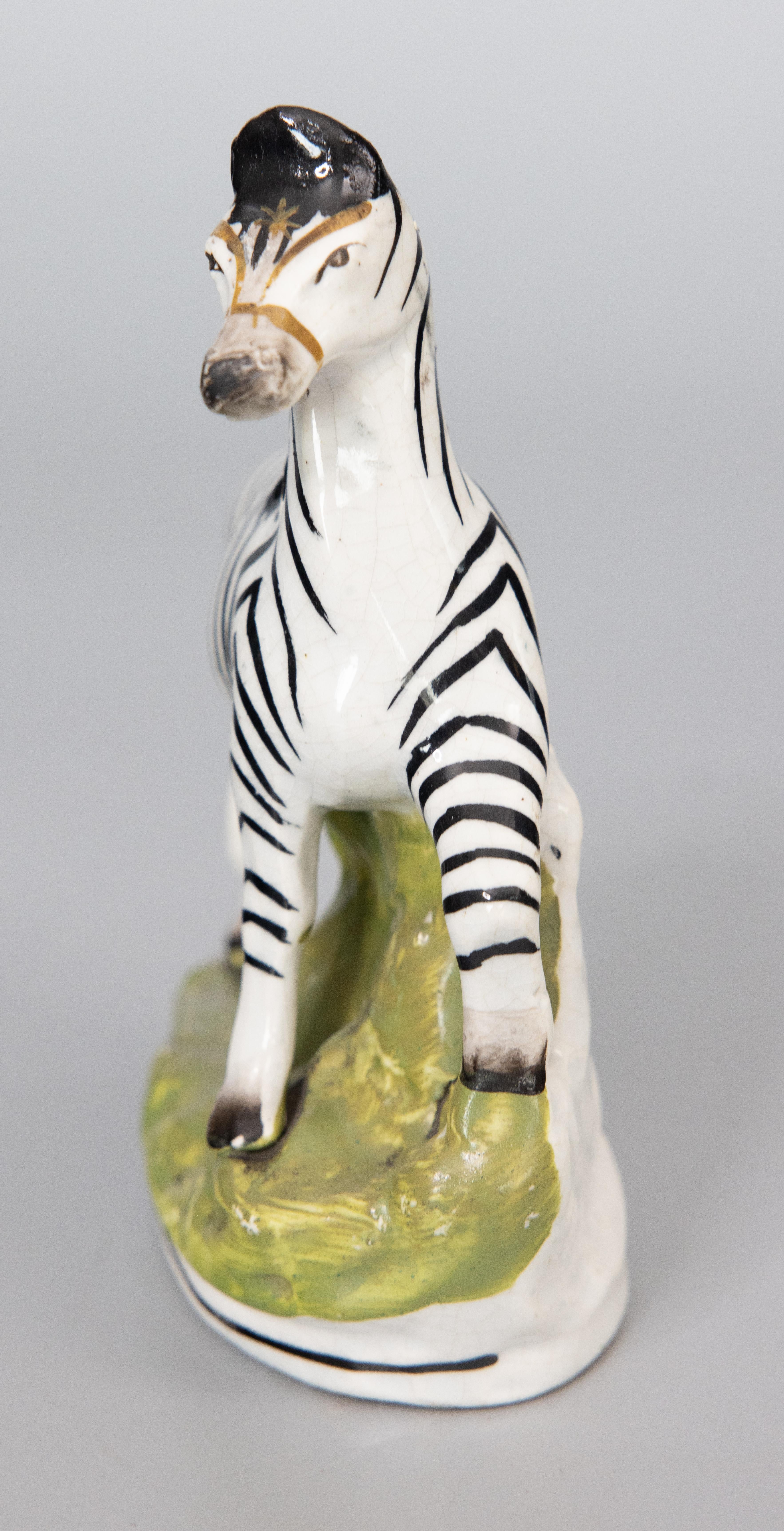 A superb 19th-Century English Staffordshire prancing zebra figurine. This charming zebra is hand painted with fine details and would be perfect for display or added to a collection.

DIMENSIONS
5