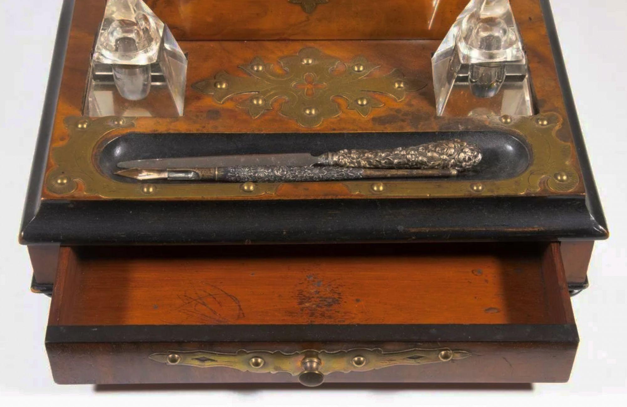 Late 19th century English stationary box and inkstand, consisting of a stationary box with hinged lid and interior fitted with silk covered insert, set on an inkstand with two clear crystal ink bottles and pen well with sterling handled letter