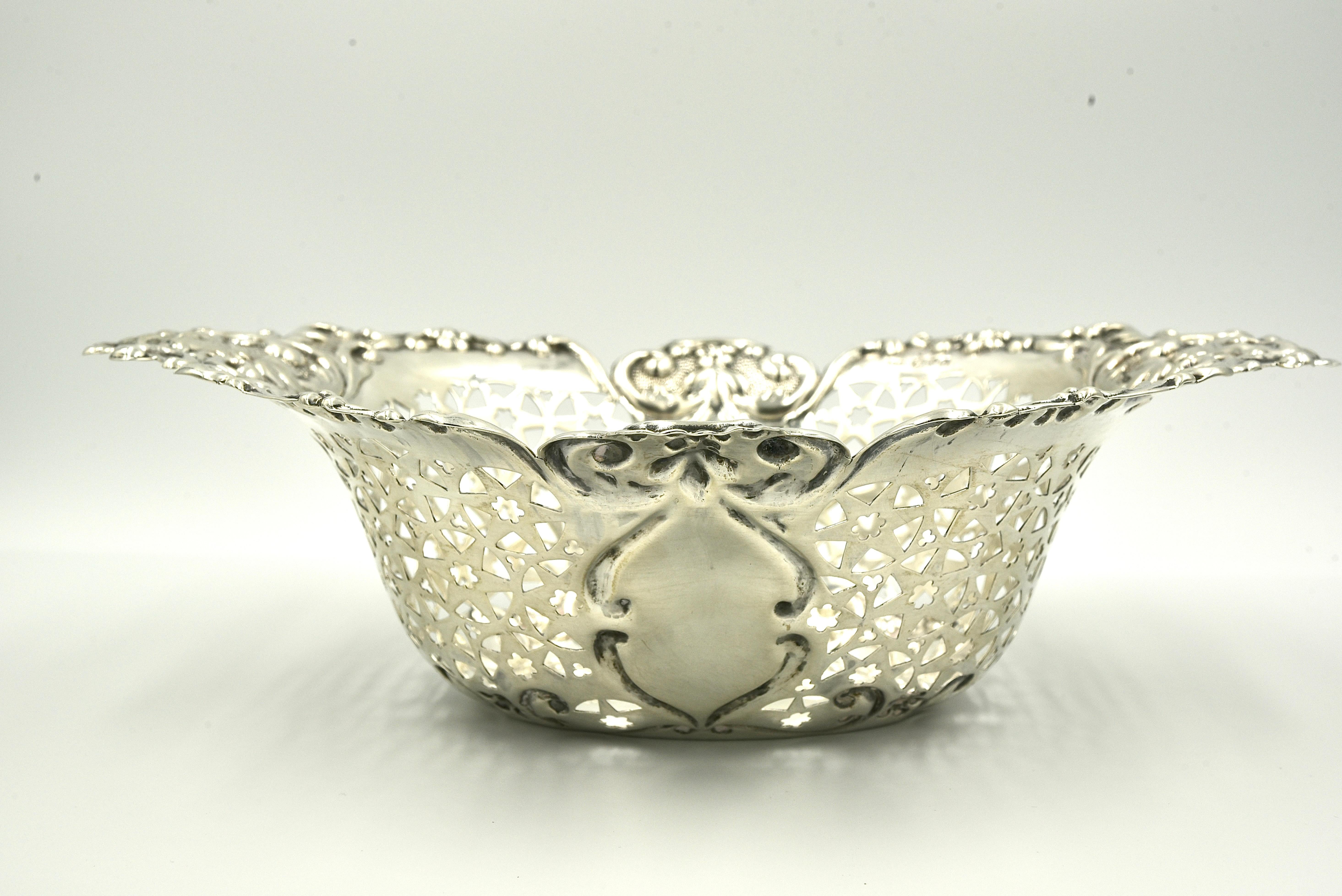 A very decorative and versatile sterling silver Victorian fruit basket with typically Victorian busy and elaborate decoration. It is a high quality basket and it has been made from a good gauge of silver which gives it a sturdy feel and a deep