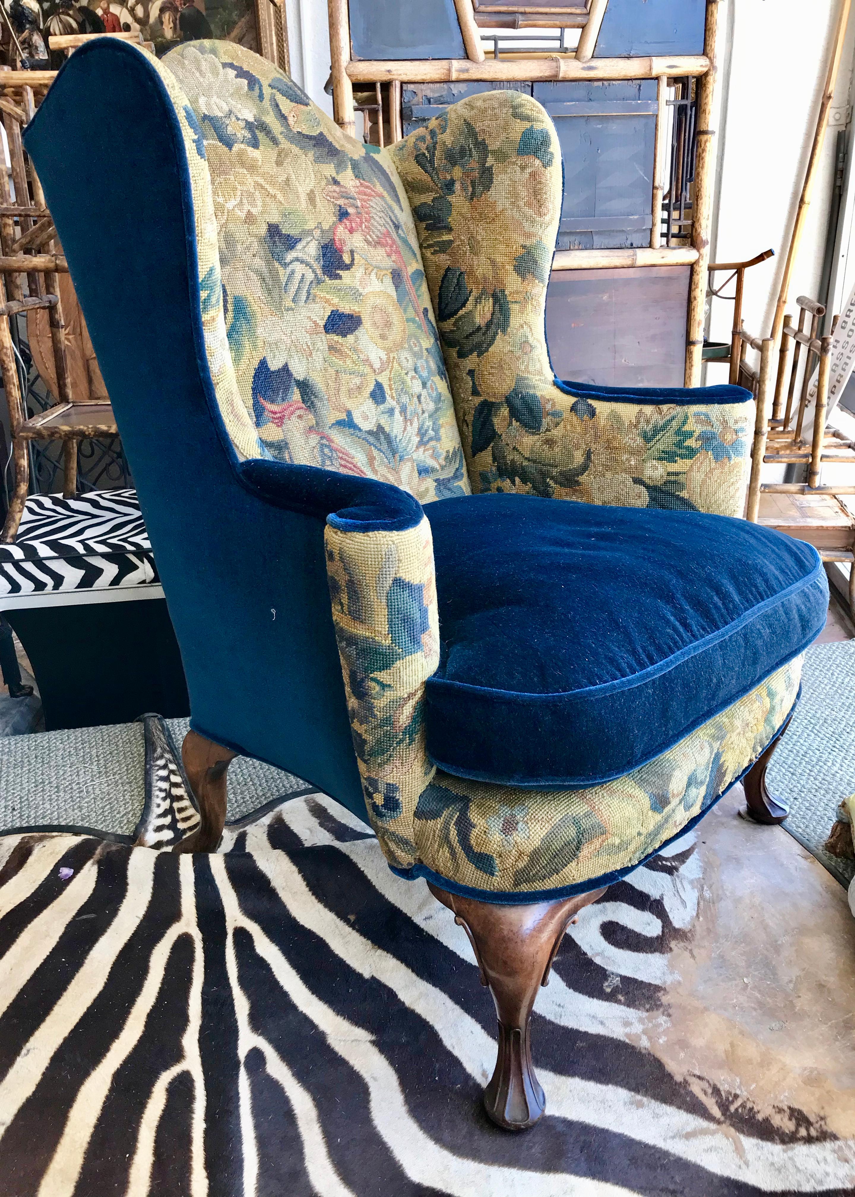 The chair is upholstered in a rich royal blue velvet and accented with an outstanding
