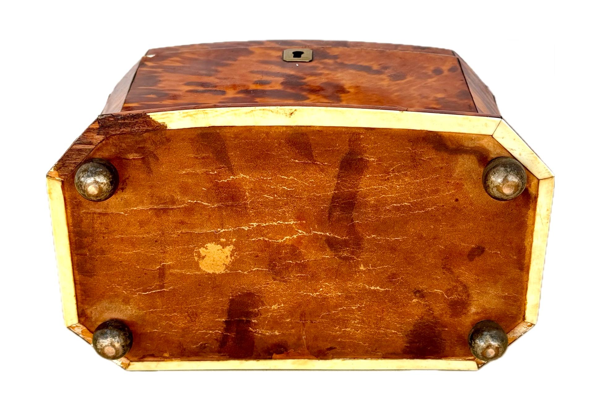 19th Century Tortoise Shell Tea Caddy. Caddy is rectangular in shape and opens to a divided interior with silver inlay. The divided interior was used to store different tea types of tea leaves. These caddies were beautifully crafted and were kept in