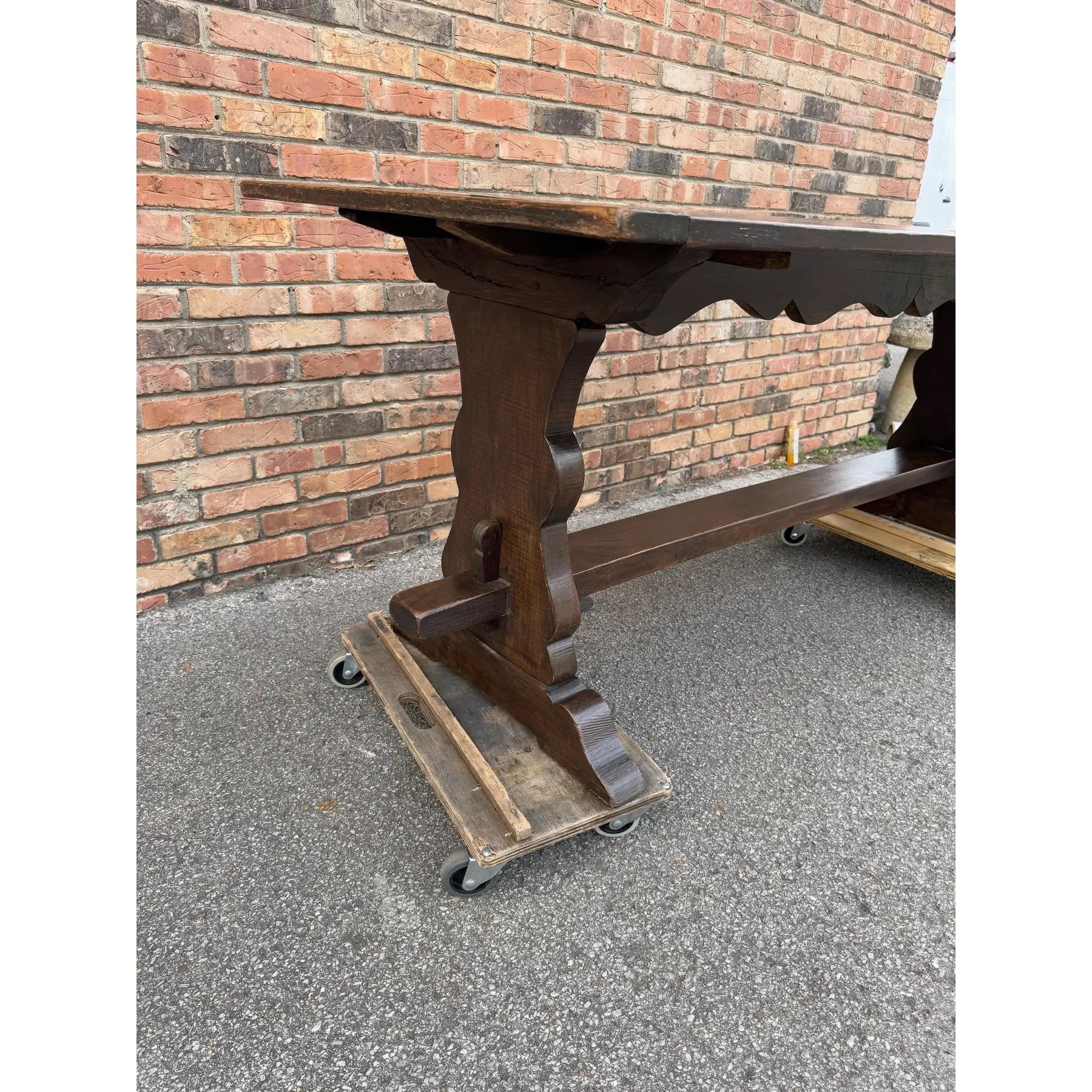 This is a beautiful late 19th century French dining table! The oak wood has a aged darkened tone, with lovely natural detail visible along the top and sides. This piece is set on a trestle base, with shapped supports for a little added elegance.