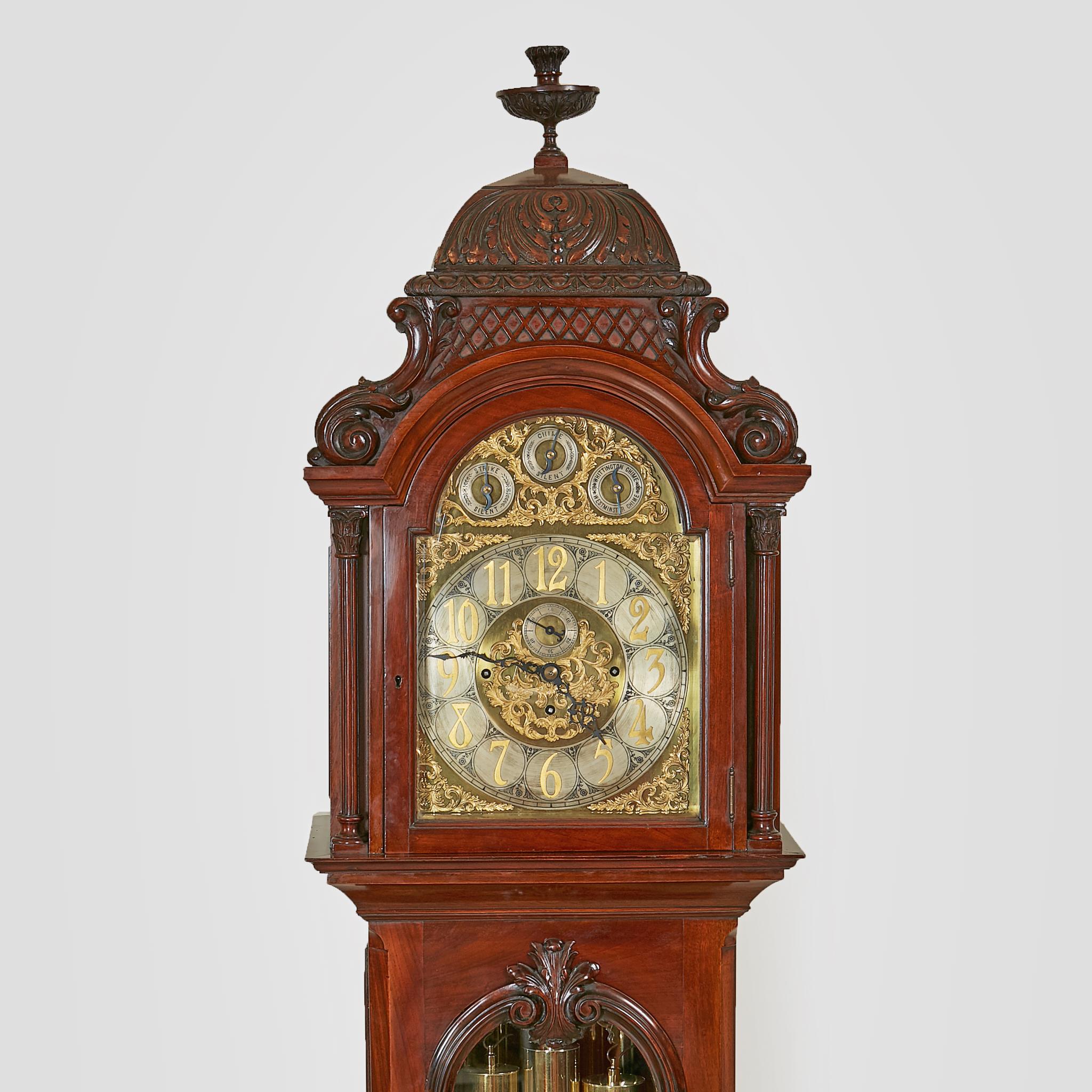 A spectacular late 19th century longcase Grandfather clock with an eight day movement and chiming on nine brass tubes. The very elaborate designed face with Arabic Numerals enclosing a subsidiary seconds dial in the center, a small switch to the