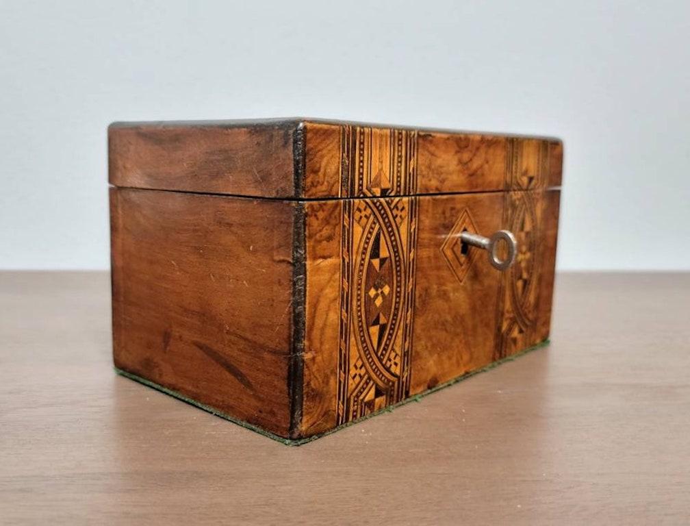 A well-made antique, circa 1830, English tea caddy with stunning marquetry inlays, warm coloring, superb detailing, and luminous rich patina!

When tea first arrived in Europe in the 17th century it was very much a luxury item (costing 3-6 months