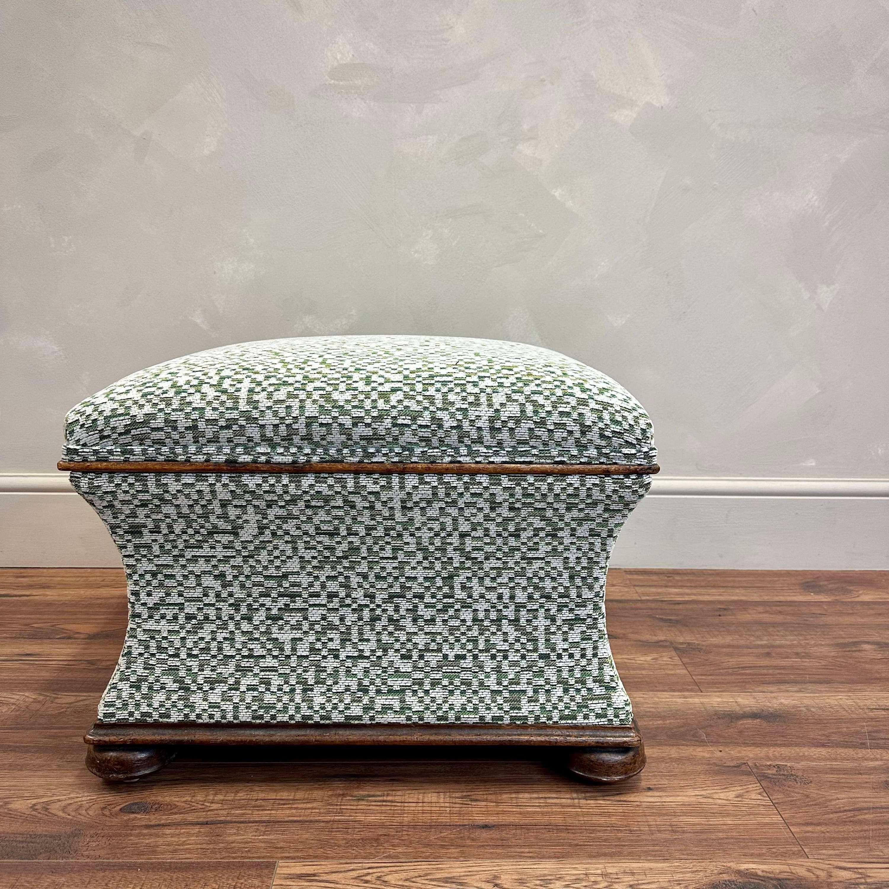 English, 19th Century upholstered cinched waist footstool.
Walnut base and lid with turned bun feet and castors.
Lovely quality, hardwearing green patterened fabric with calico lining.
Height - 42 cm 
Width - 48 cm
Depth - 42.5 cm
Please message if