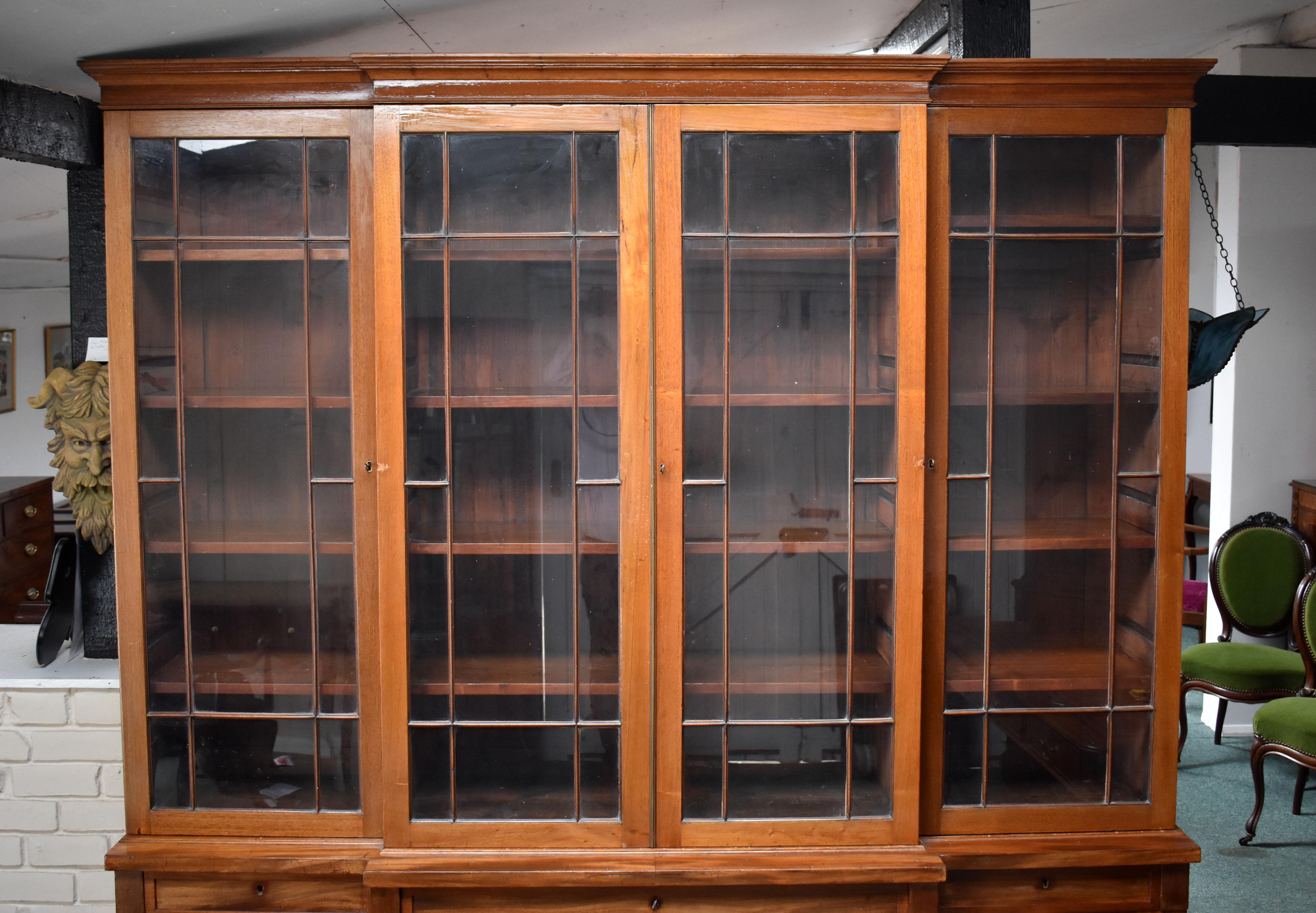 For sale is a Victorian breakfront bookcase, have a flared cornice, above four glazed doors, each opening to four adjustable shelves, above cupboards to the centre and ends of the base, raised on bracket feet. The bookcase is in good untouched