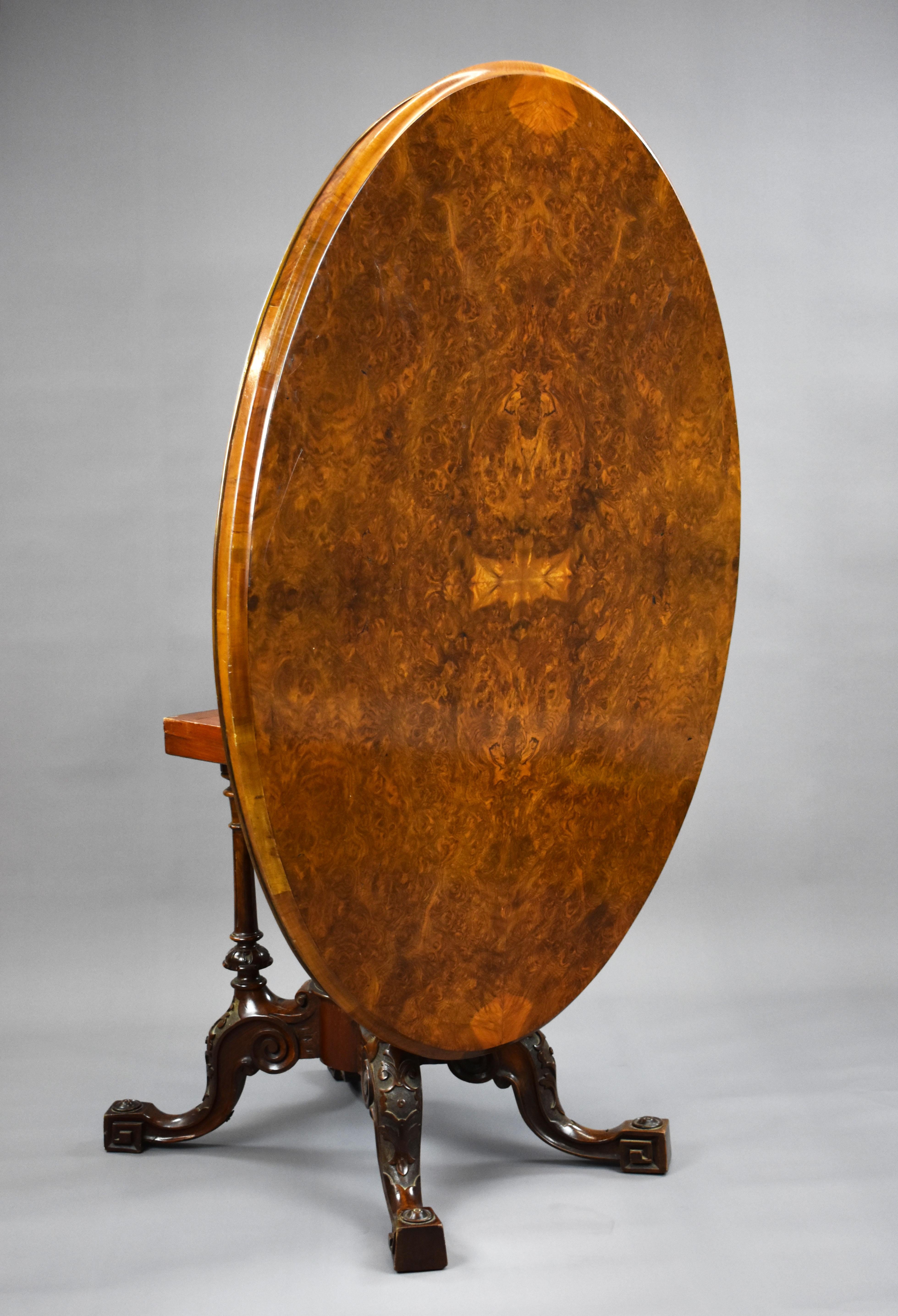 For sale is a Victorian burr walnut oval loo table, having an oval burr walnut top, above a birdcage base with a central finial, standing on elegantly shaped and carved legs. The table remains in good condition for its age retaining a good colour