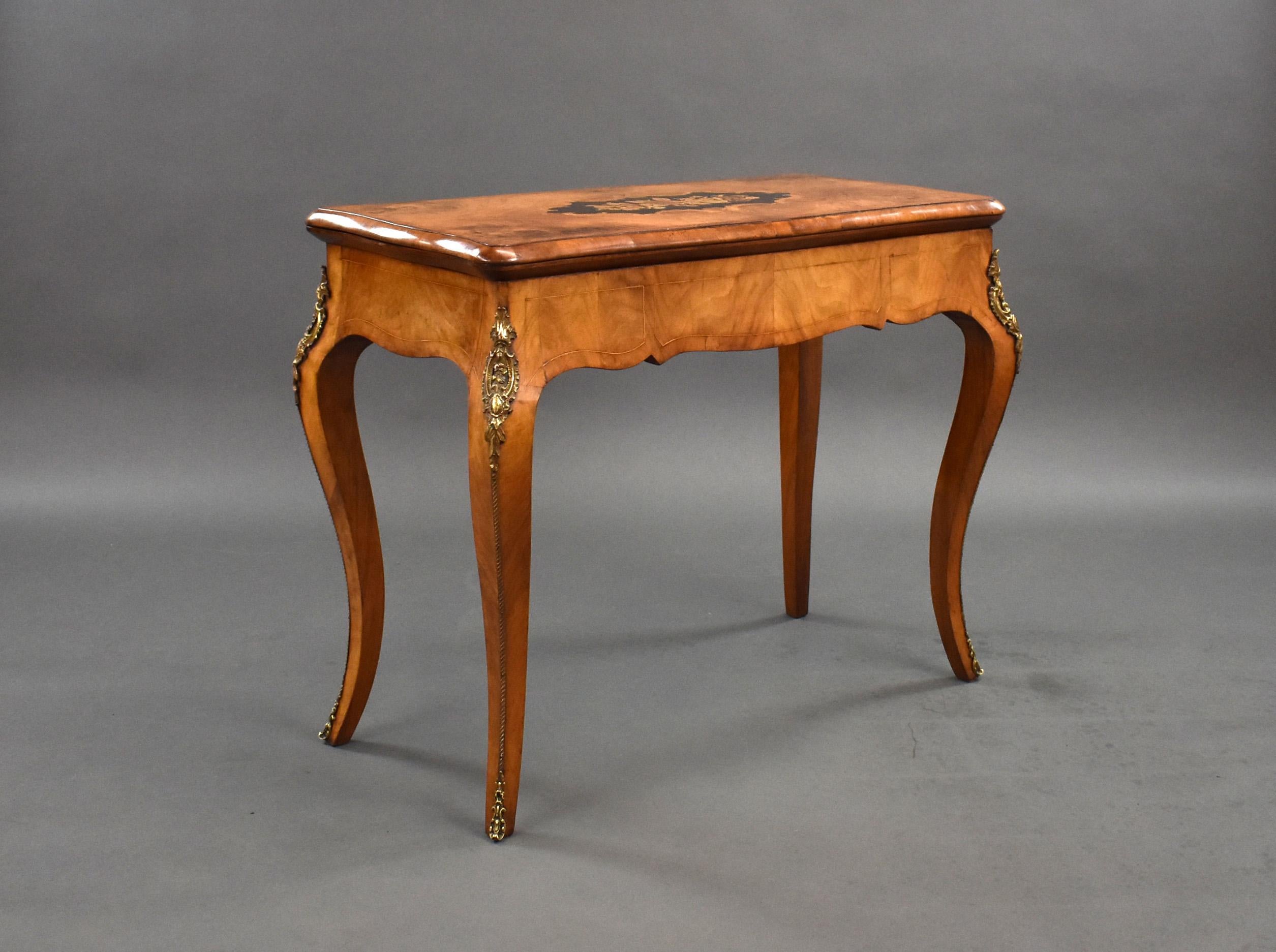 For sale is a good quality Victorian burr walnut marquetry inlaid fold over card table, having a marquetry inlaid top, this swivels and folds over to reveal a green baize lined interior, standing on elegant legs decorated with metal mounts, the card