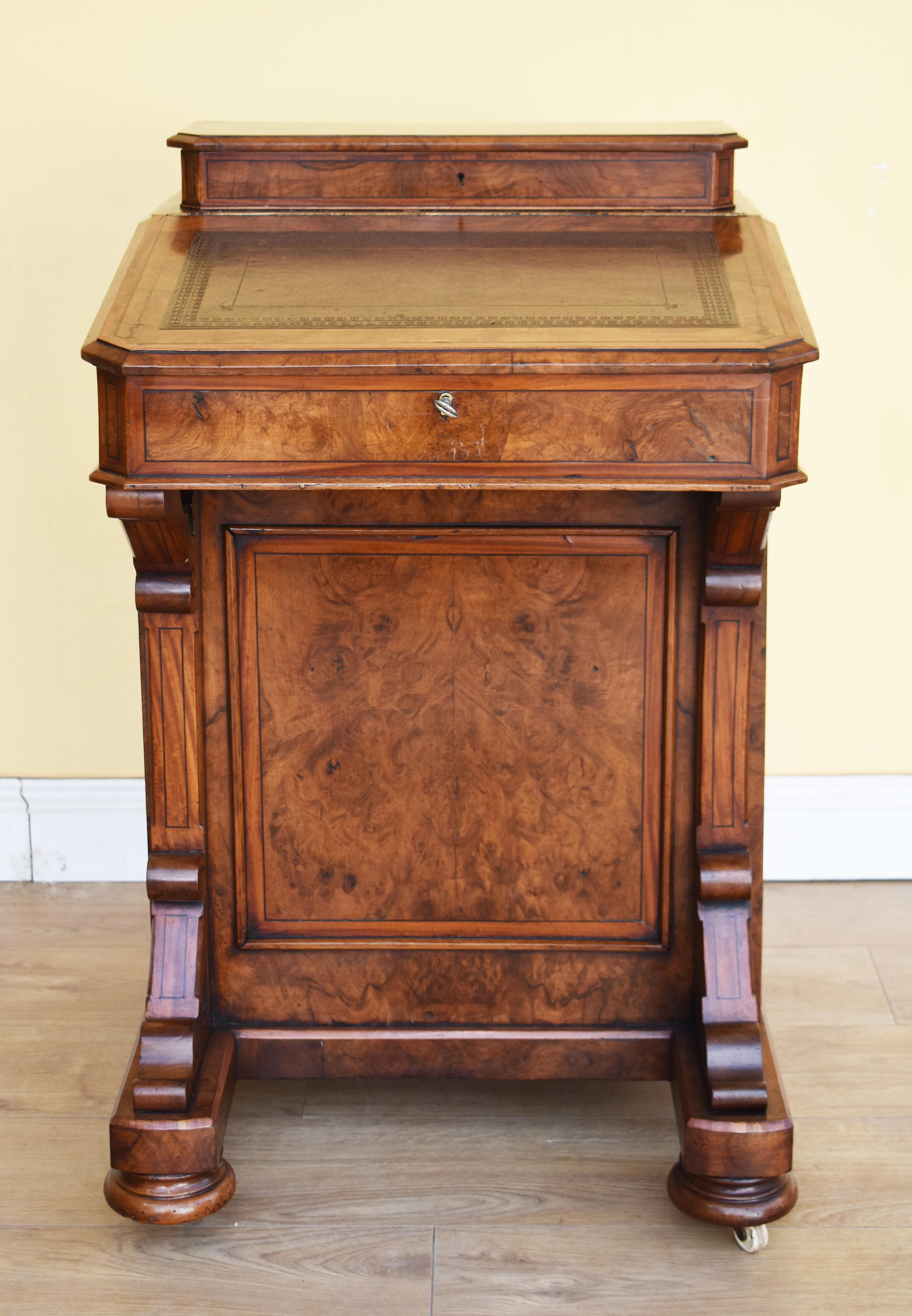 For sale is a Victorian burr walnut Davenport, the top having a rising lid, opening to reveal a fitted interior for stationary storage. Below this, the writing surface also lifts to reveal ample storage space. The davenport has one paneled side, and