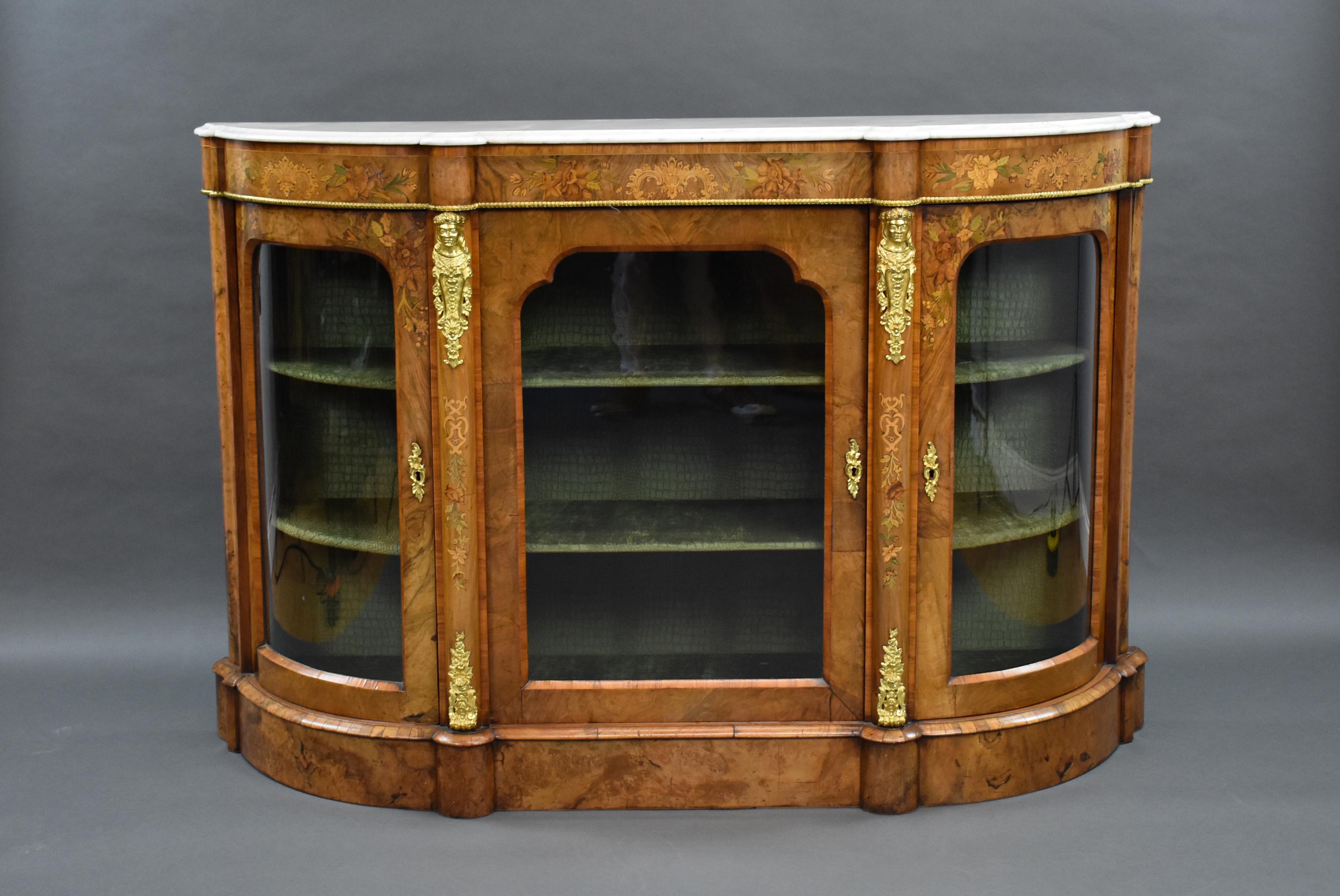 For sale is a very good quality Victorian burr walnut and floral marquetry inlaid D ended credenza, having tulip wood cross banding to the doors and edges of the cabinet. The credenza is decorated with bronze gilt ormolu mounts and mouldings, it