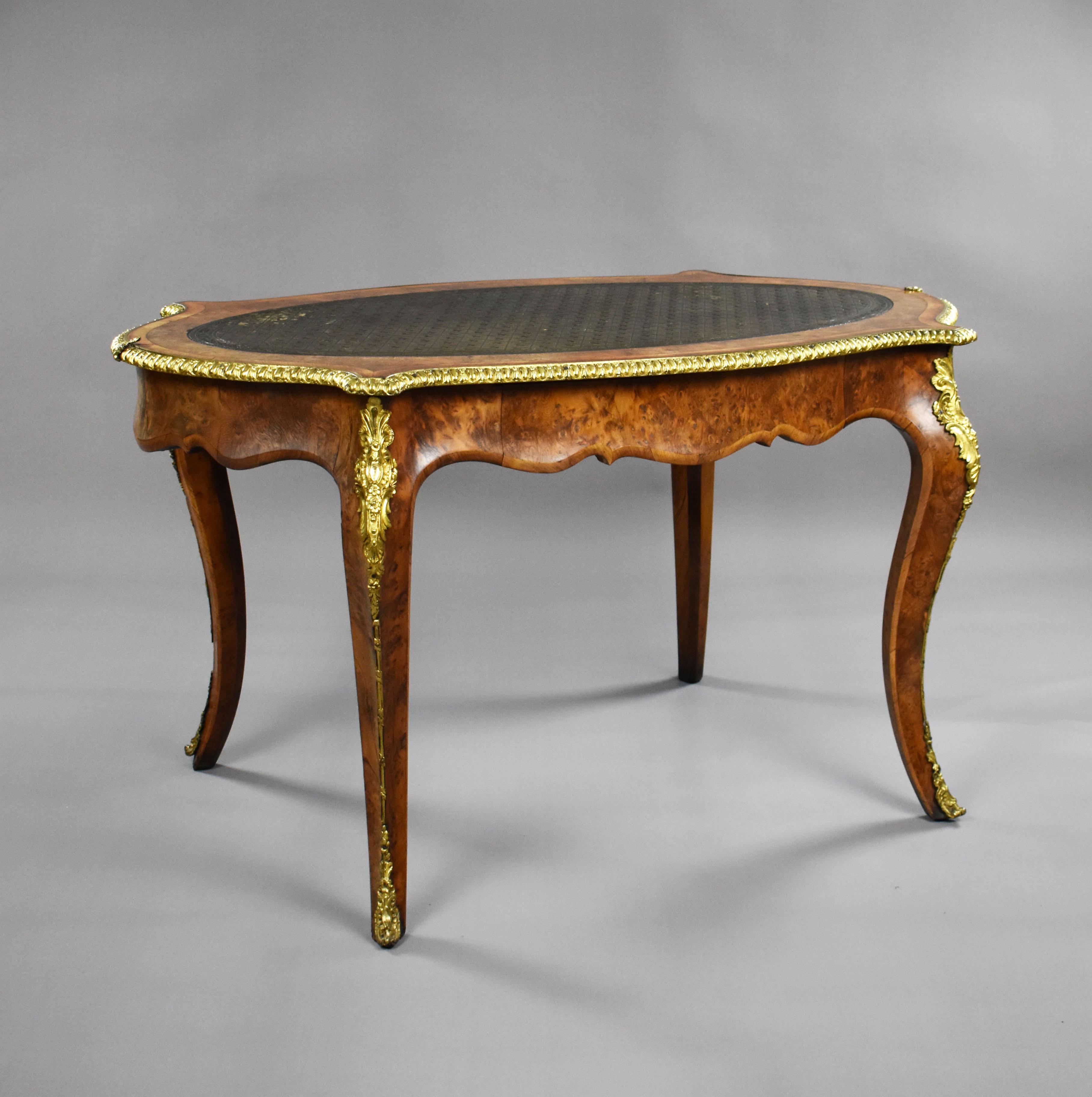 A good quality burr yew, tulipwood banded and gilt brass mounted bureau plat by Howard & Sons, remaining in good condition, showing very minor losses and wear commensurate with age and use. 

Measures: Width: 127cm depth: 72cm height: 71cm.