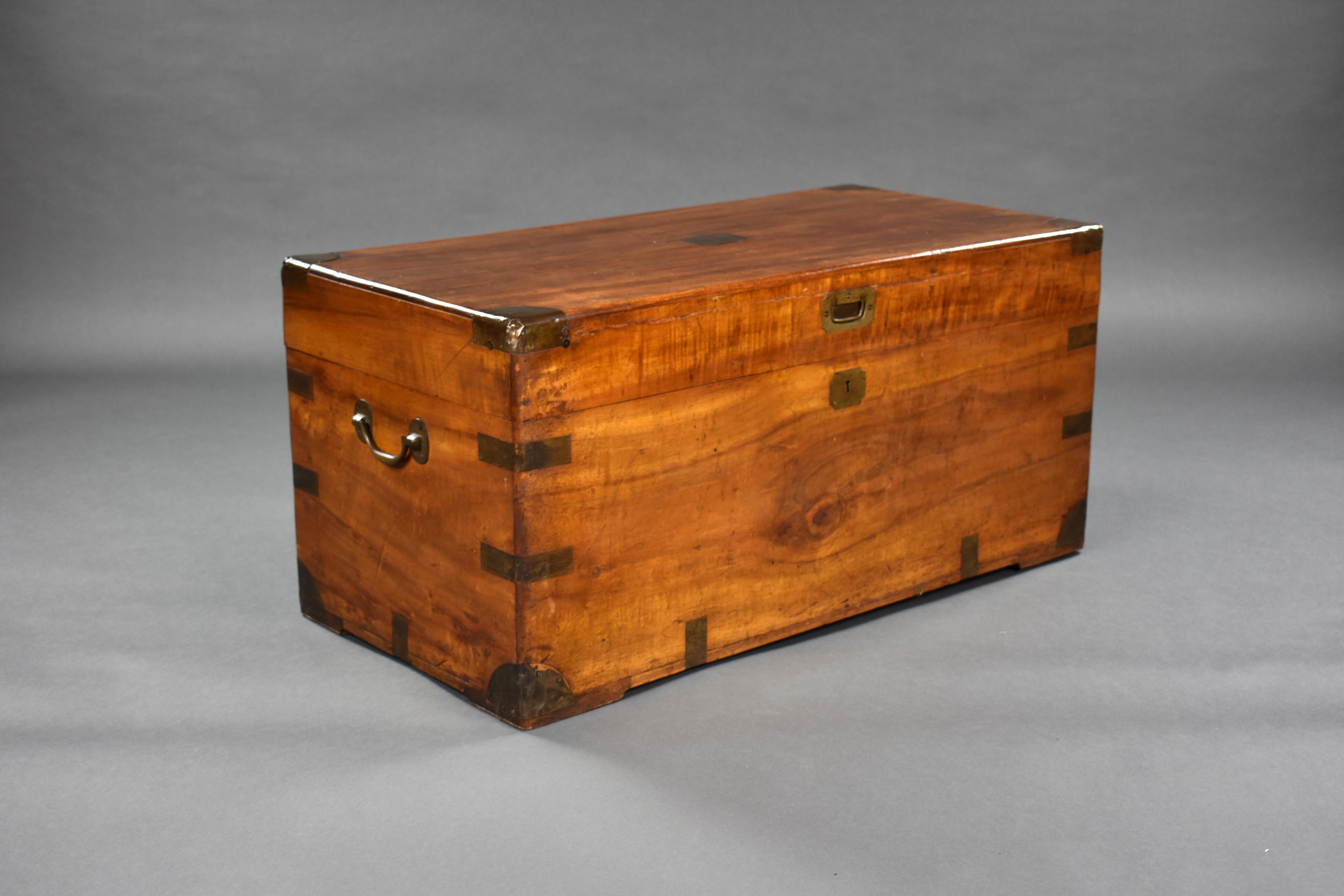For sale is a good quality Victorian camphor wood trunk, having brass straps and corners. The hinged lid opening to reveal ample storage space. The trunk is complete with its original carrying handles and remains in very good condition, showing