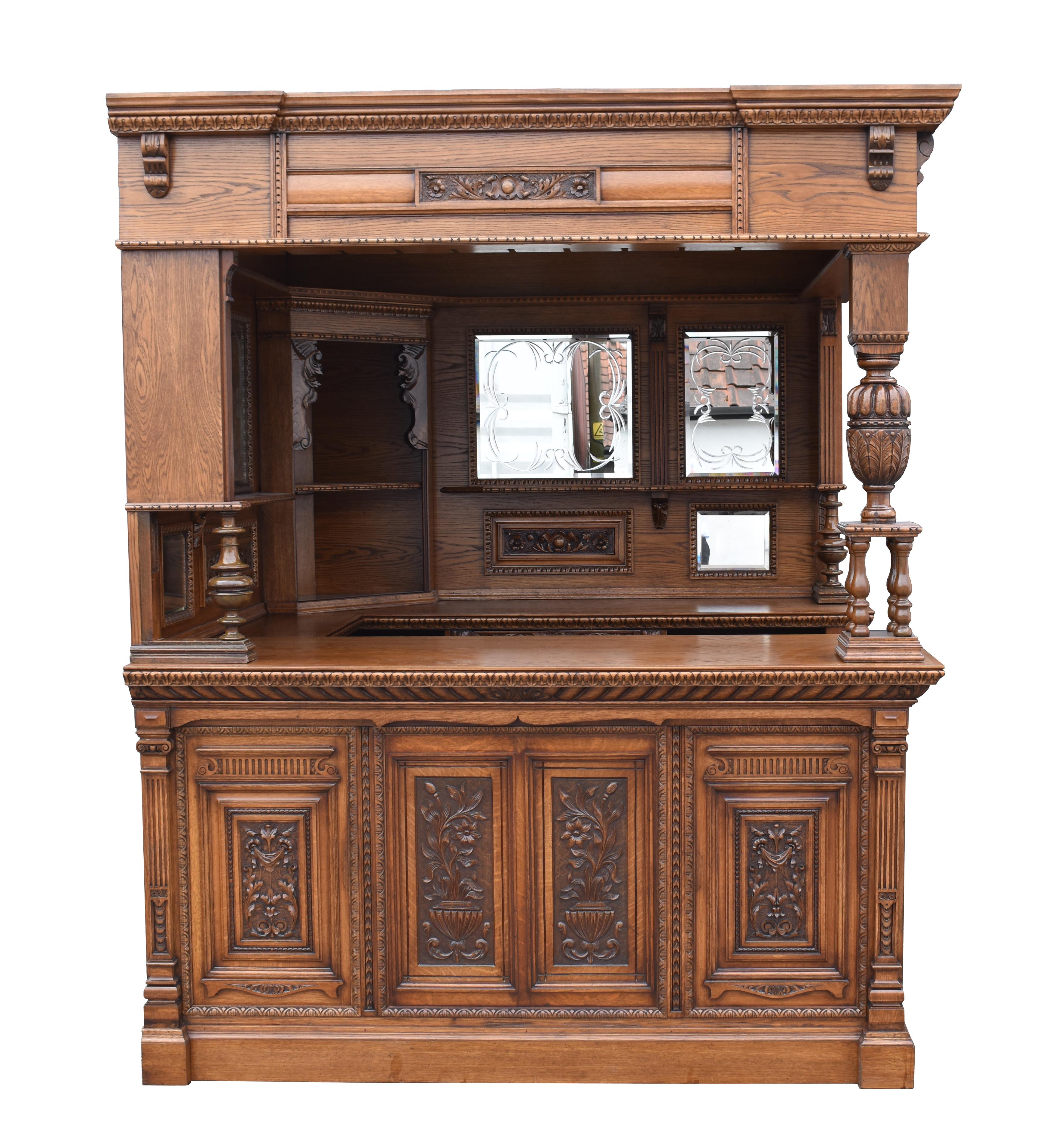 For sale is a good quality Victorian and later carved oak corner bar. The canopy having a stained glass ceiling, supported by two sections each with hand beveled and engraved mirrors and ornate carved panels. Below is a single drawer in the back bar