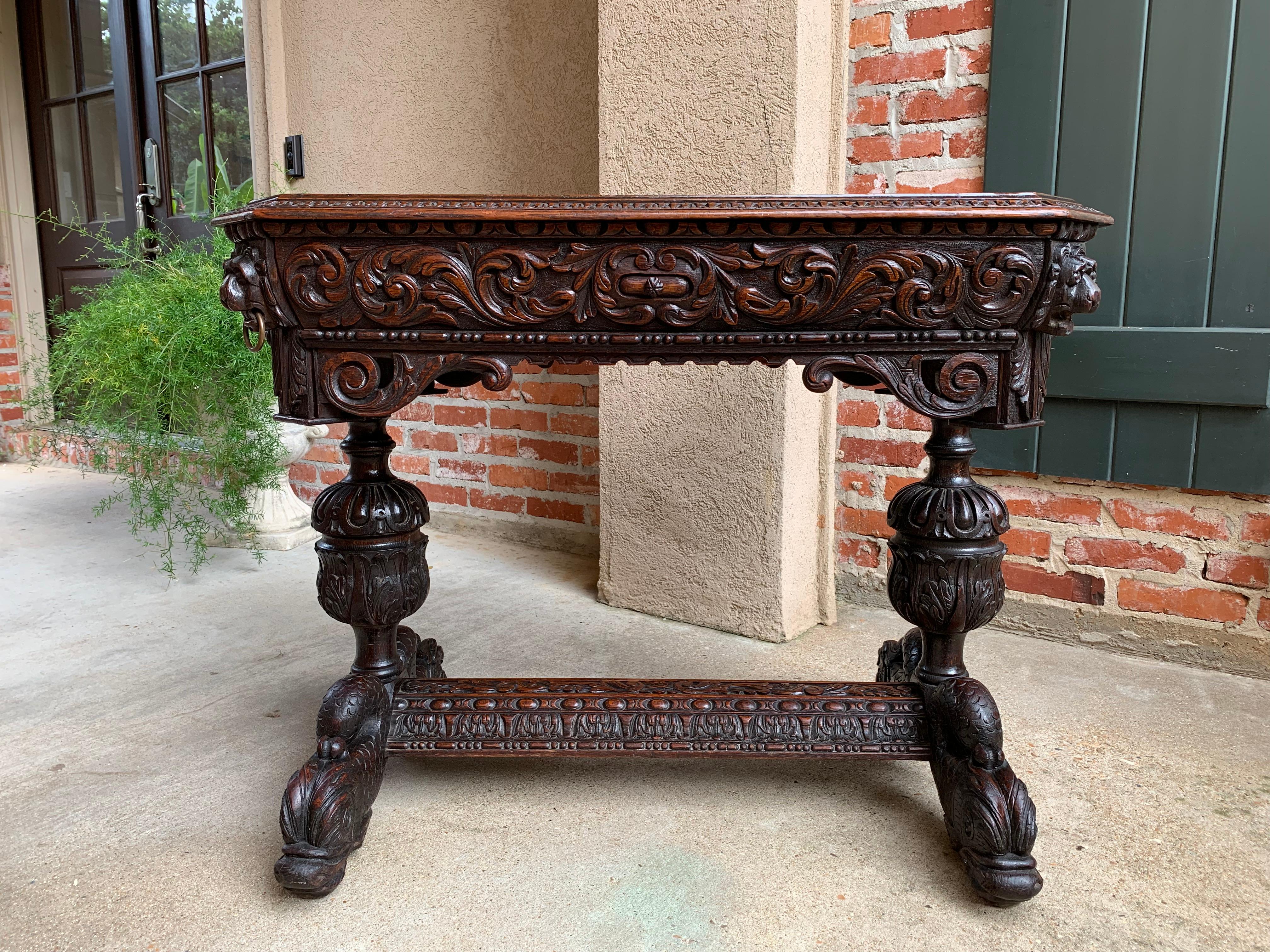 Direct from England, a wonderful antique English carved oak table or “bureau plat” desk, commonly called a “dolphin table” for the ornate serpent or ‘dolphin’ feet~
~SMALLER SIZE, in addition to using as a sofa table or desk, imagine this as a