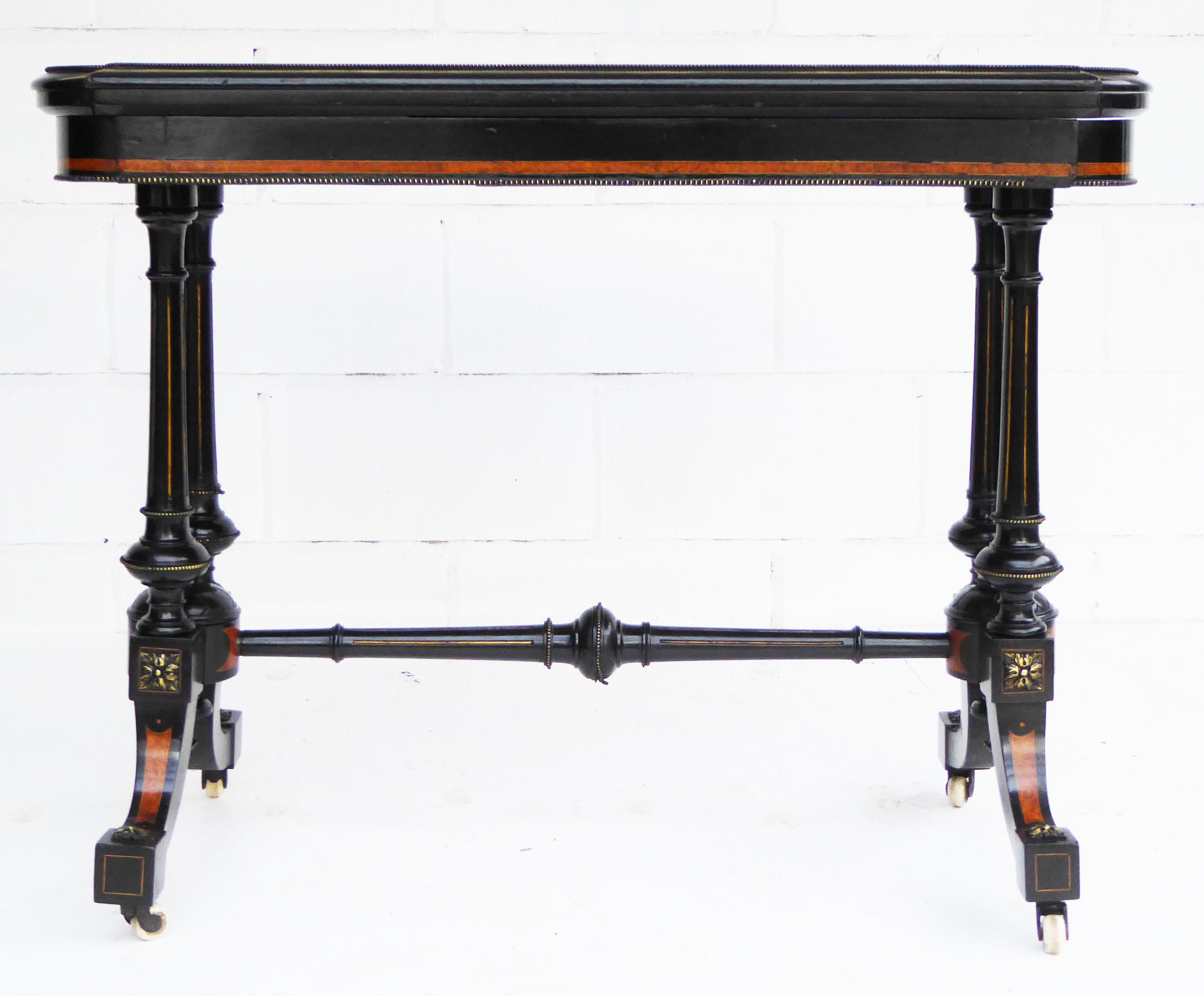For sale is a fine quality Victorian ebonised and inlaid fold over card table. The top of the table is nicely inlaid and swivels to reveal storage space for cards etc. The top then folds over to reveal a shaped red tooled baize. Below the top are