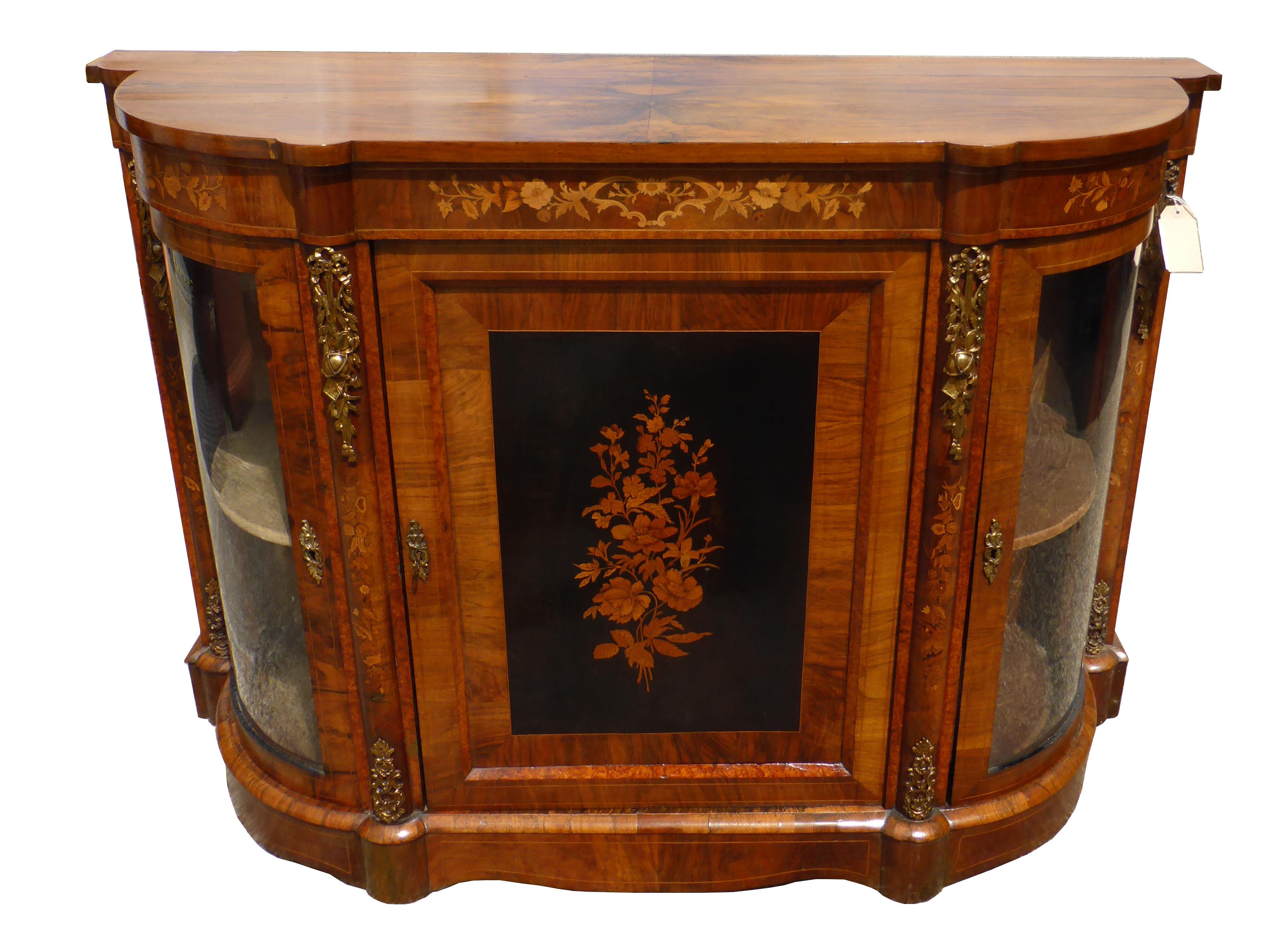 For sale is a good quality 19th century Victorian figured walnut and marquetry credenza, being bowed in shape, having a marquetry inlaid centre door, flanked by a bowed and glazed doors on either side. The credenza is in good condition, having minor