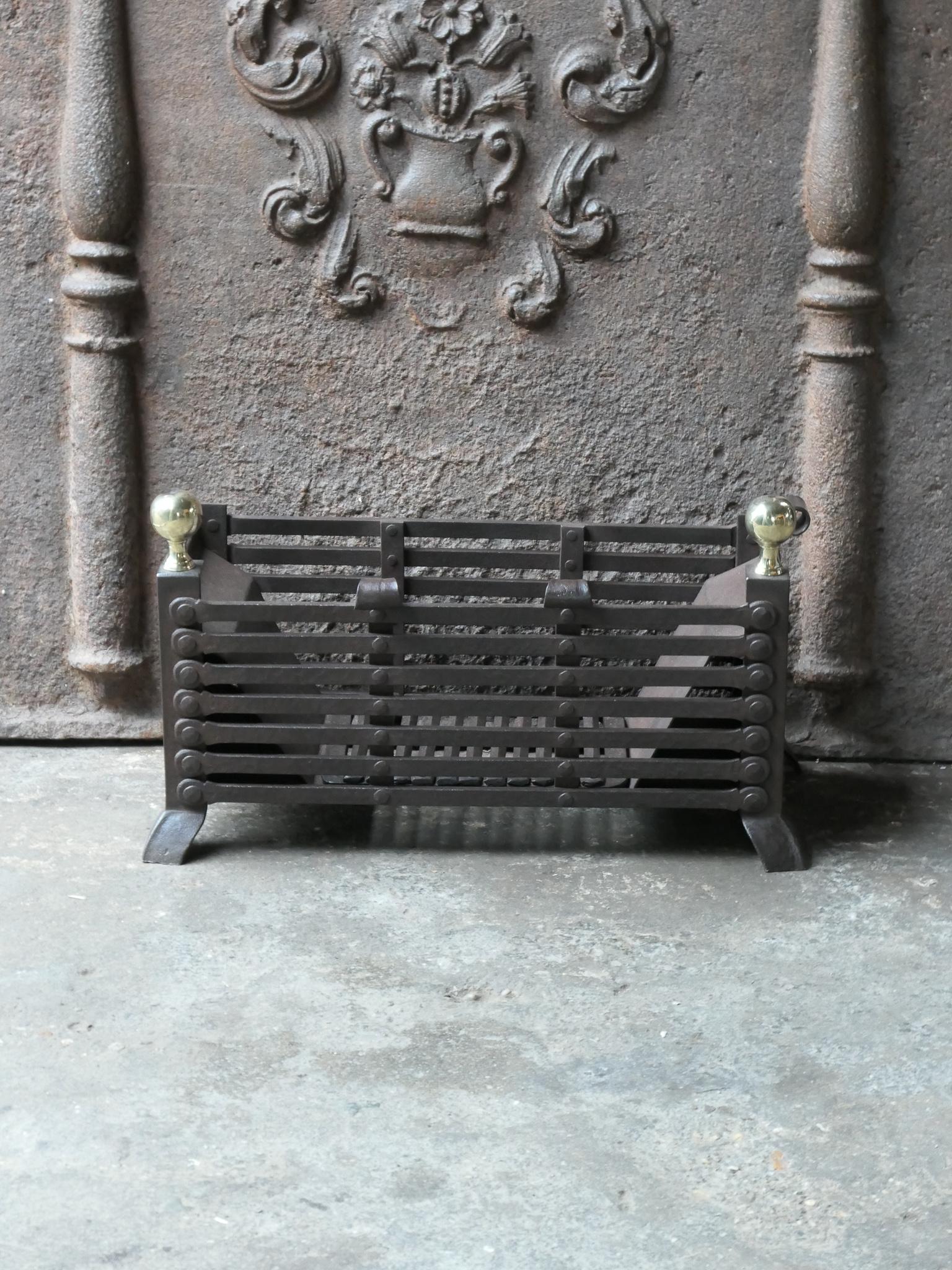 19th century English Victorian fireplace basket, fire grate made of wrought iron, cast iron and polished brass. The fireplace grate is in a good condition and is fit for use in the fireplace.







