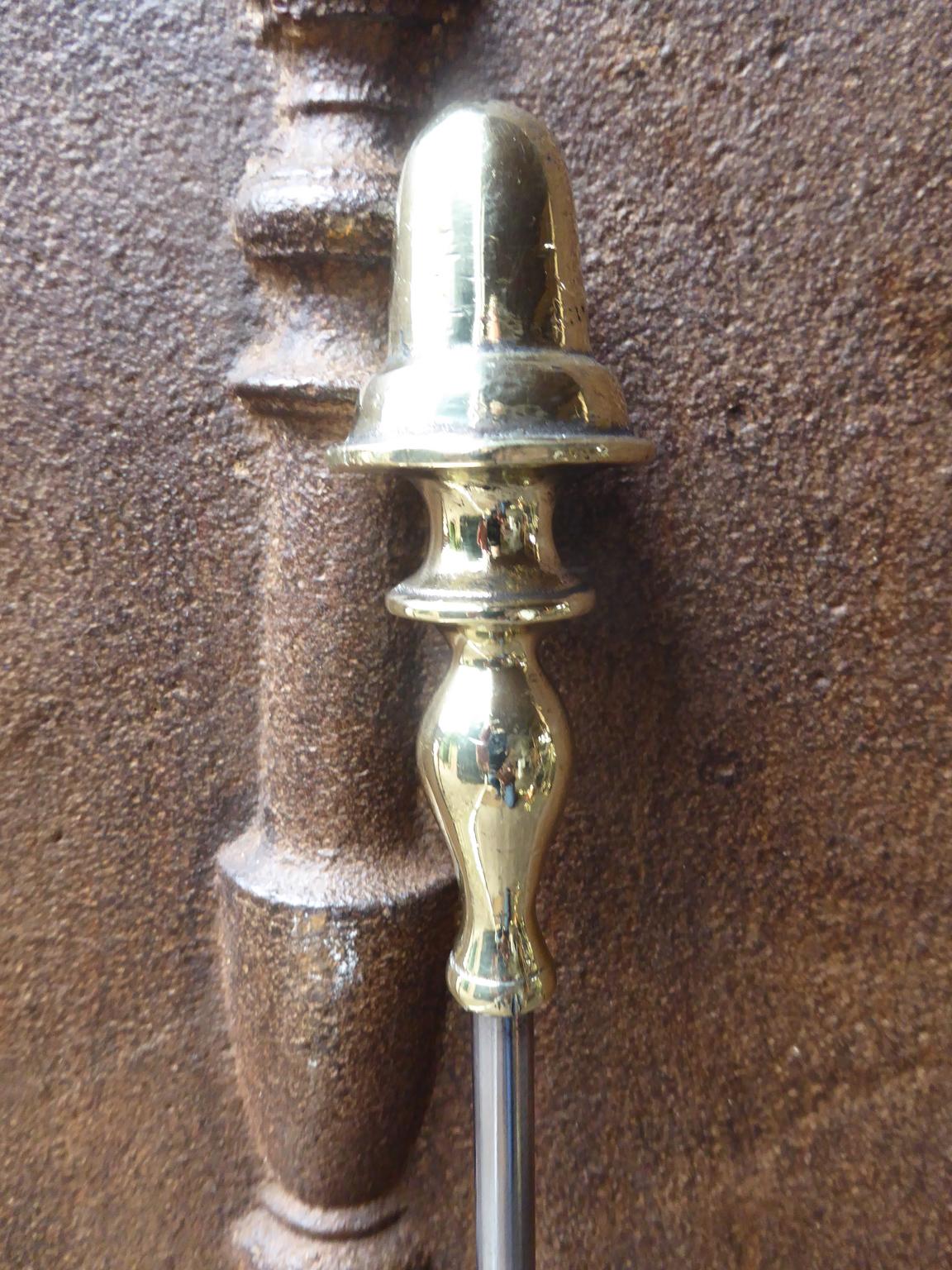 19th century English Victorian fireplace poker made of polished steel and polished brass.








